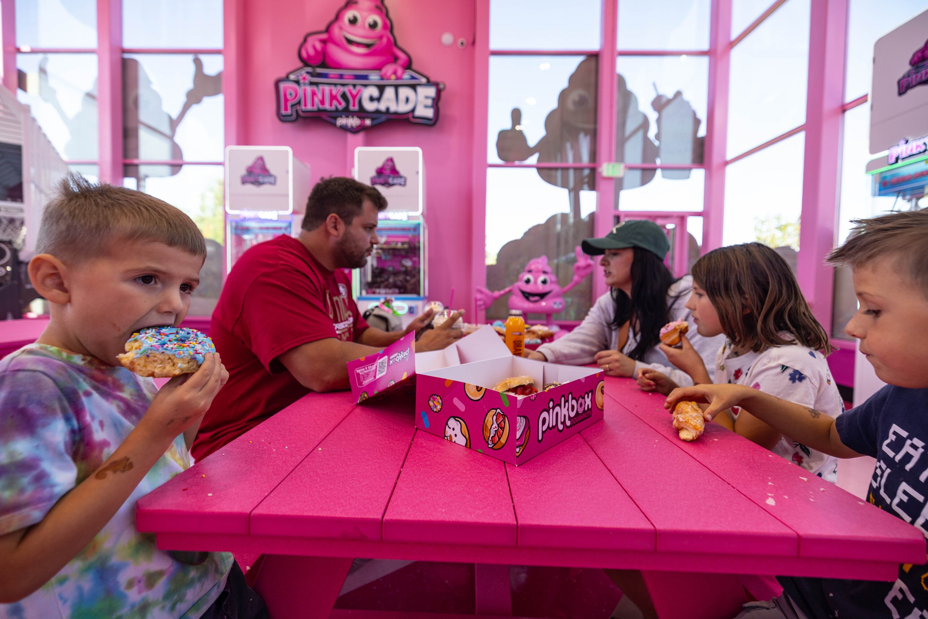 The Giles family eats doughnuts at the new Pinkbox Doughnuts located at 10235 State St. in Sandy on Sunday.