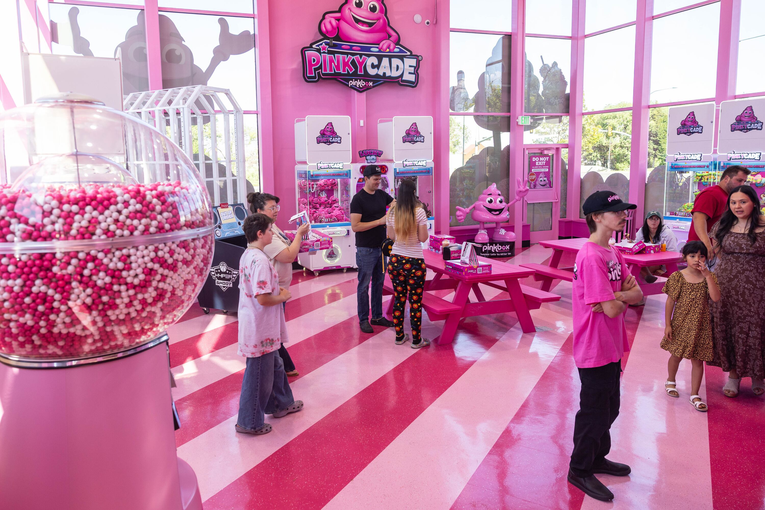 Customers enjoy the “Pinkycade” at the new Pinkbox Doughnuts located at 10235 State St. in Sandy on Sunday.