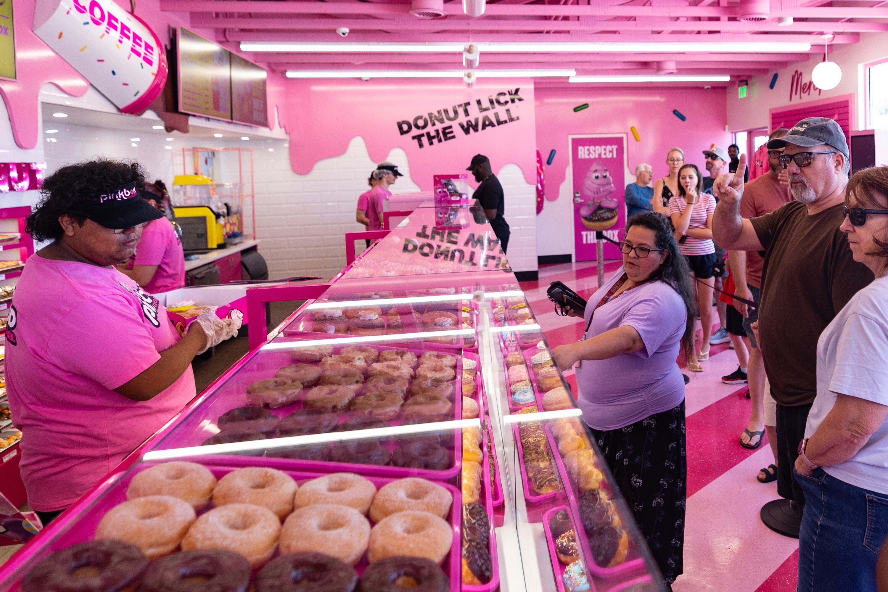 Customers line up for doughnuts at the new Pinkbox Doughnuts located at 10235 State St. in Sandy on Sunday.