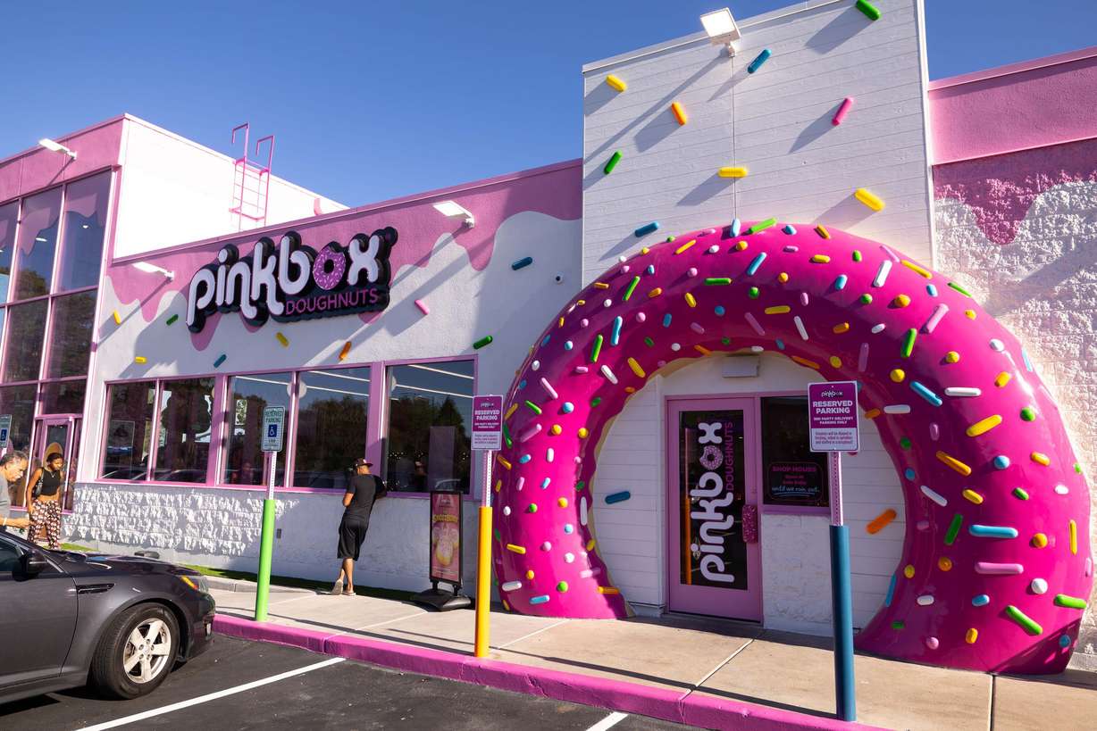 Customers arrive at the new Pinkbox Doughnuts located at 10235 State St. in Sandy on Sunday.
