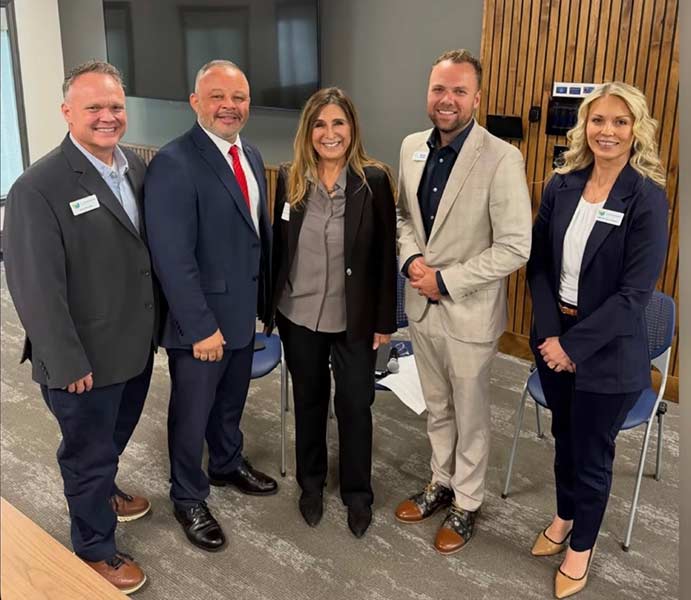 Stephanie Taylor-Thompson, right, with Jeremy Manwaring, left, Monty Burks, second from left, Victoria Seaman, center, and Brennan Summers, chief government affairs officer for the Idaho Dept. of Education, following Friday’s roundtable discussion in Idaho Falls.