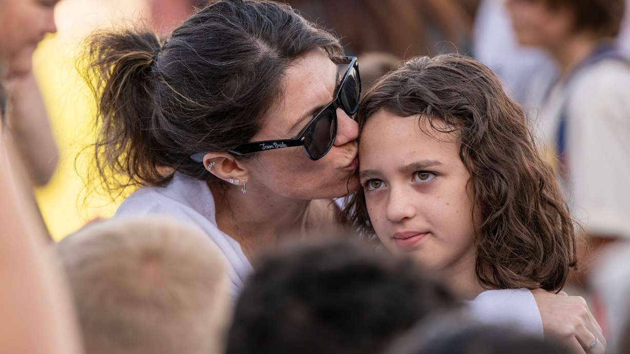 Lauren Doane kisses her daughter Raelynn McKan’s head as Sandy Elementary welcomes its students back to school with a celebratory atmosphere and a red-carpet walk on Monday. Hundreds of thousands of Utah kids will be heading back to school this week, so expect an "outbreak" of first-day-of-school butterflies.