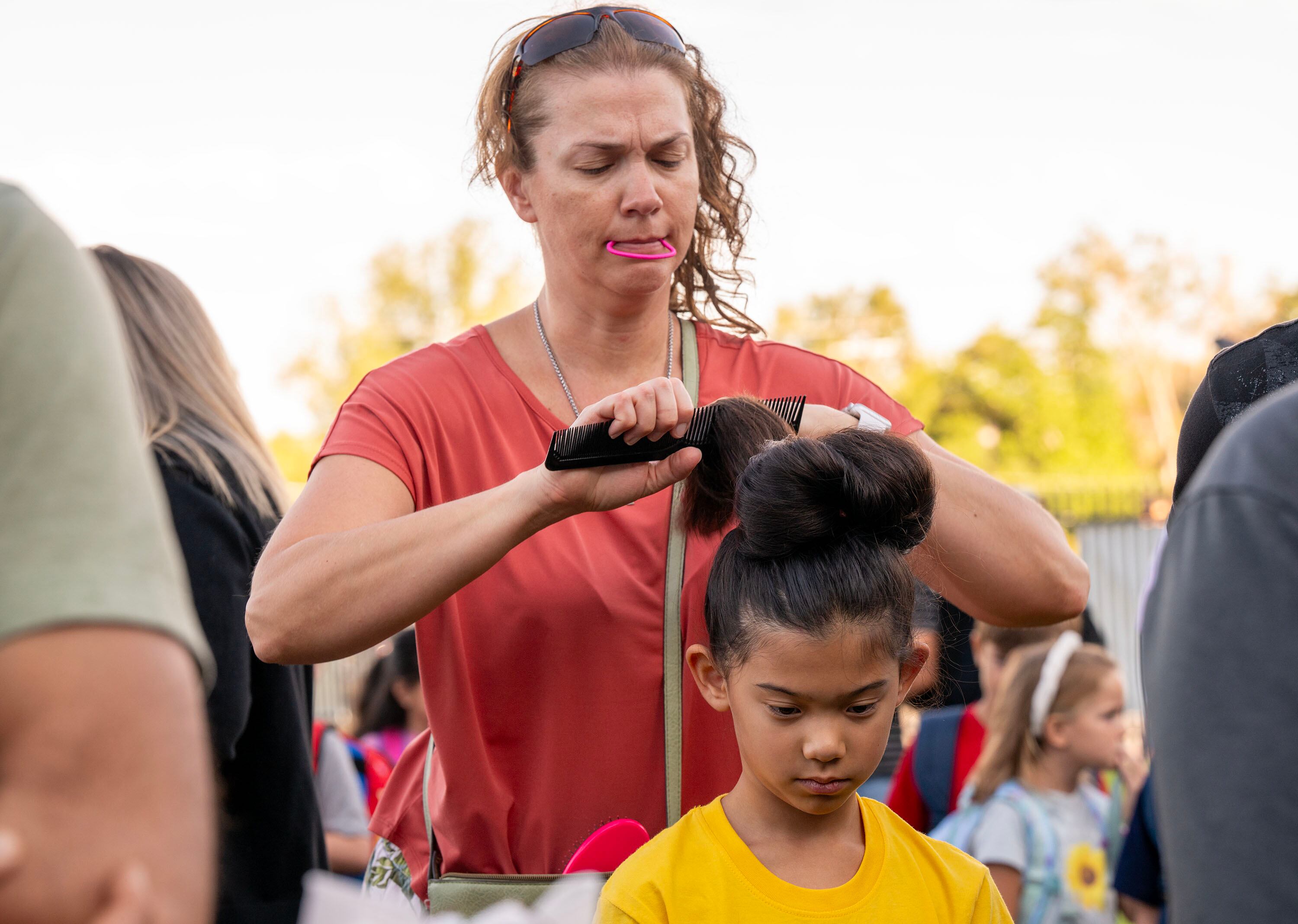 Sarah Derricott puts the final touches on her daughter Sophia Lee’s hair as Sandy Elementary welcomes its students back to school with a celebratory atmosphere and a red-carpet walk on Monday.