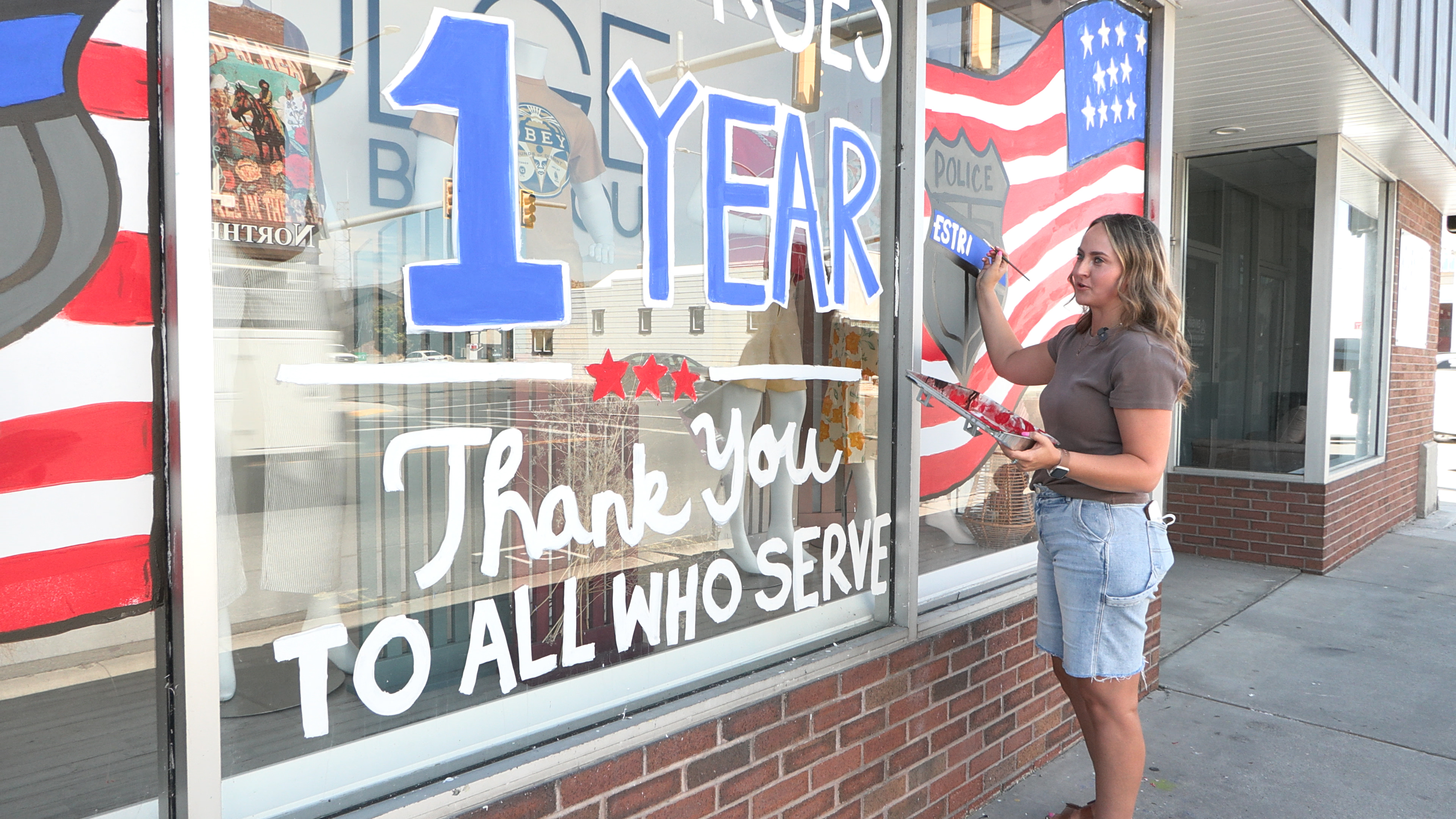 Taryn Hammons finishes up a mural, painted mostly by her employers— the owners of Indulge Boutique, along Main Street in Tremonton.