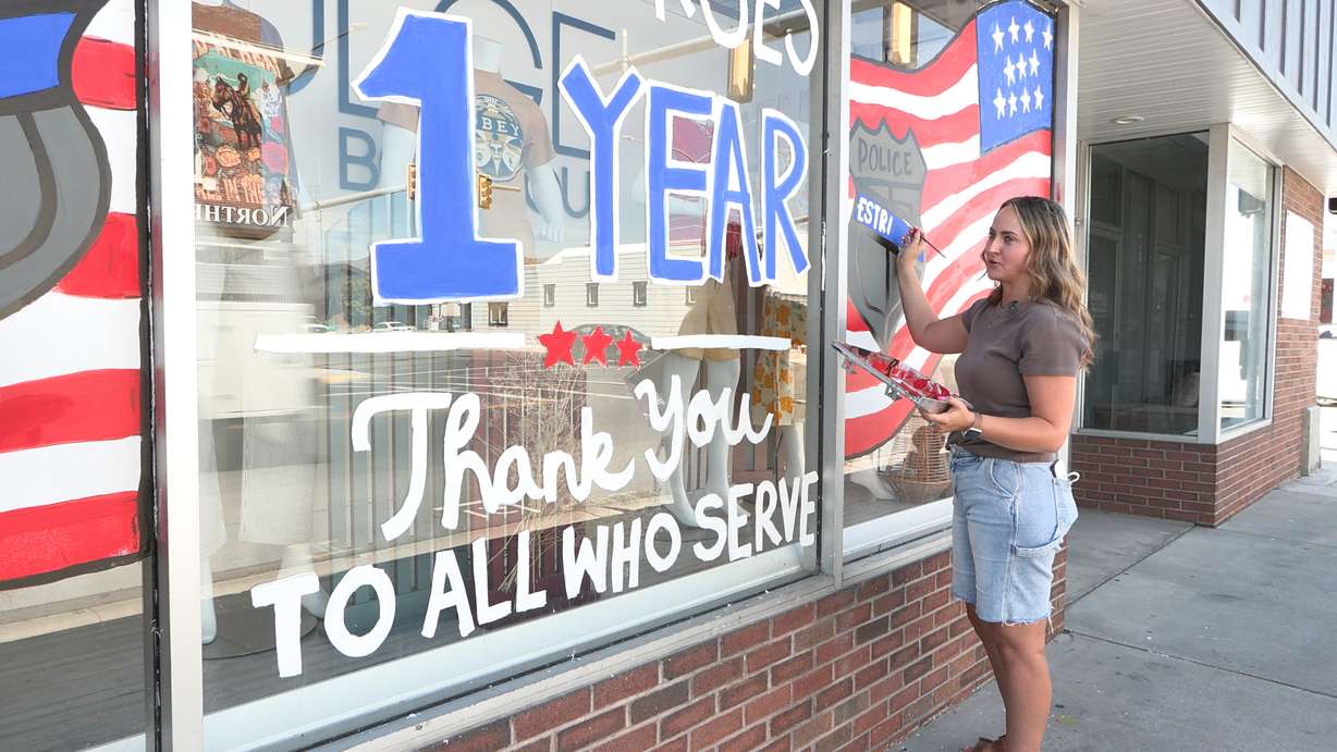 Taryn Hammons finishes up a mural, painted mostly by her employers— the owners of Indulge Boutique, along Main Street in Tremonton.