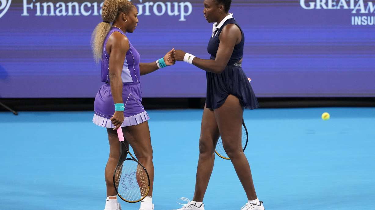 Serena Williams, left, first bumps Venus Williams, right, both of the United States, during a women's doubles match against Marta Kostyuk, of Ukraine, and Peyton Stearns, also of the United States, at the Cincinnati Open tennis tournament, Monday, Aug. 17, 2026, in Mason, Ohio.