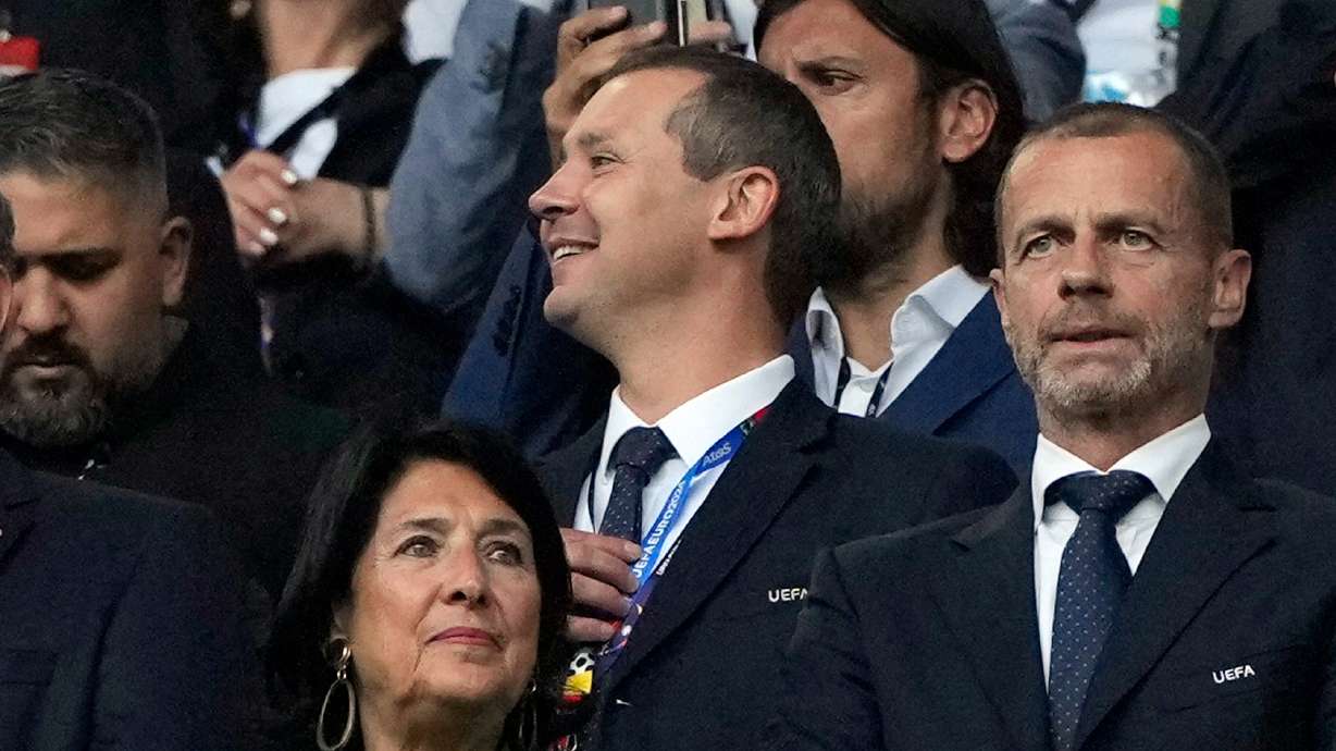FILE - UEFA's deputy general secretary Kevin Lamour, centre, looks on as he stands next to UEFA President Aleksander Ceferin, right, prior to the start of a Group F match between Turkey and Georgia at the Euro 2024 soccer tournament in Dortmund, Germany, Tuesday, June 18, 2024. K