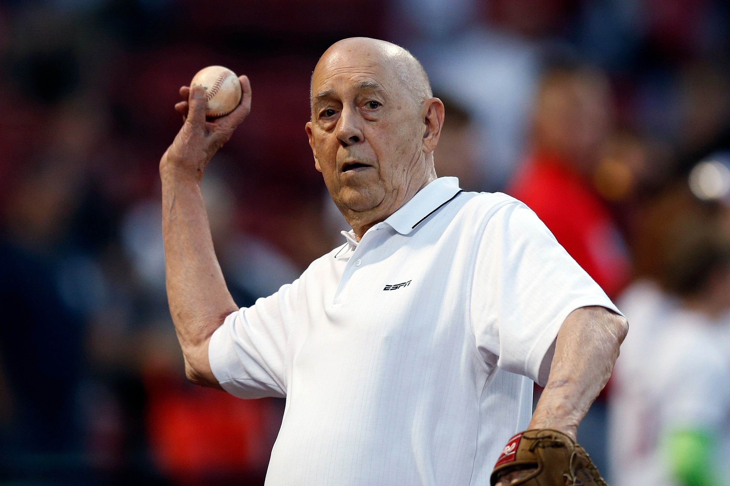 FILE - ESPN co-founder Bill Rasmussen tosses a ball before a baseball game between the Boston Red Sox and the New York Yankees in Boston, Sept. 8, 2019. 