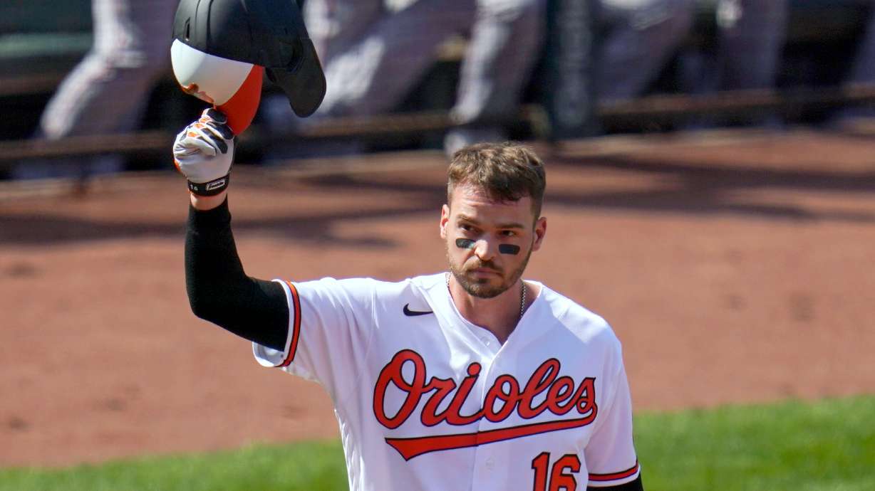 FILE - Baltimore Orioles' Trey Mancini tips his helmet as fans give him a standing ovation prior to a baseball game against the Boston Red Sox, April 8, 2021, on Opening Day in Baltimore.