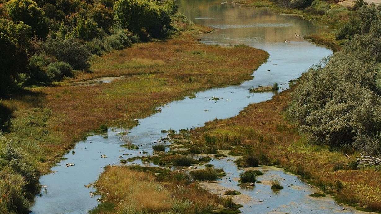 The Bear River winds below Cutler Dam near Fielding, Utah, on Sept. 18, 2003. A new DOI rule will open hunting and fishing at refuges and hatcheries.