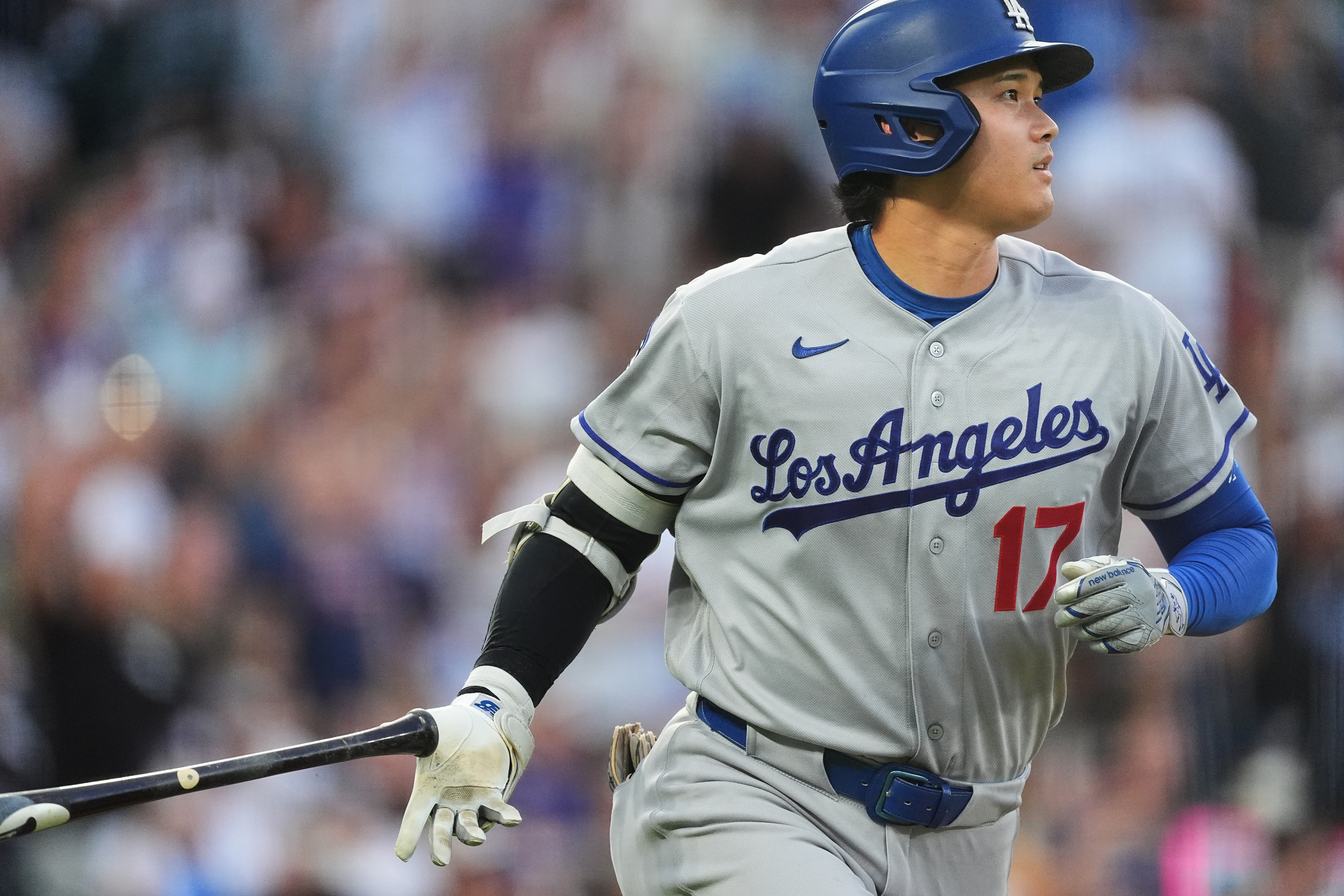 Los Angeles Dodgers' Shohei Ohtani drops his bat as he heads up the first-base line after hitting a two-run home run off Colorado Rockies starting pitcher Ryan Feltner in the third inning of a baseball game Tuesday, Aug. 18, 2026, in Denver. 