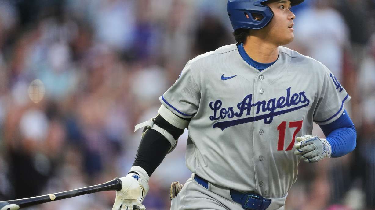 Los Angeles Dodgers' Shohei Ohtani drops his bat as he heads up the first-base line after hitting a two-run home run off Colorado Rockies starting pitcher Ryan Feltner in the third inning of a baseball game Tuesday, Aug. 18, 2026, in Denver.