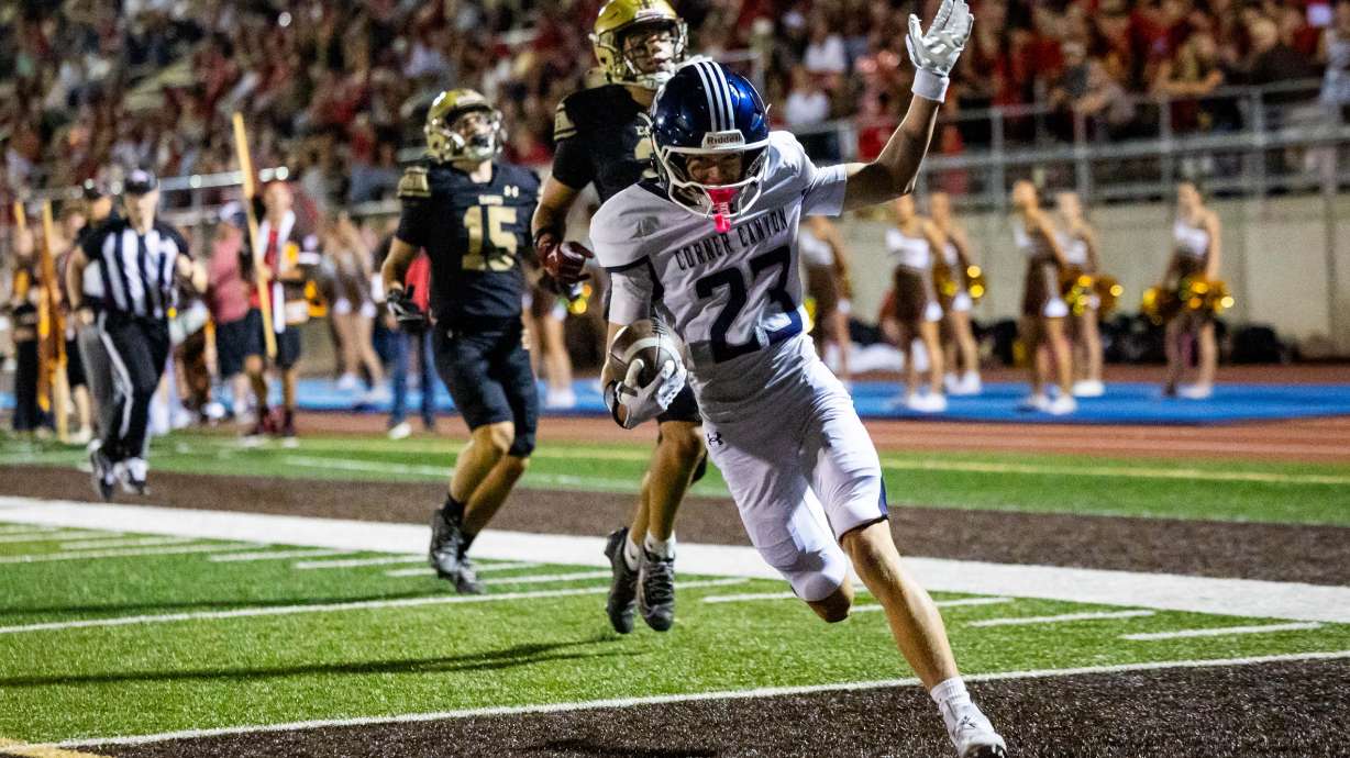 Corner Canyon Chargers wide receiver Beckam Coon (23) runs to the end zone with the ball to score a touchdown during a 6A high school football game against the Davis Darts at Davis High School in Kaysville on Friday, Aug. 14, 2026.