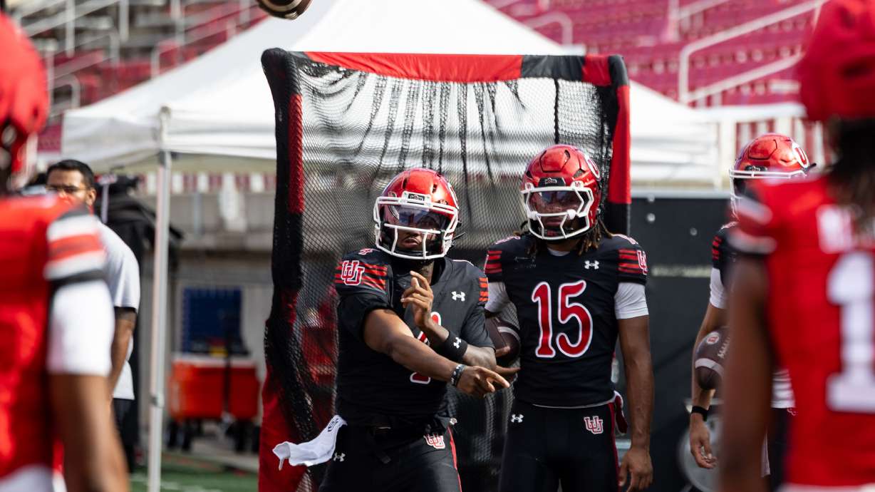 Utah’s Devon Dampier (4) passes the ball during QB drills at a University of Utah football practice held at Rice-Eccles Stadium in Salt Lake City on Saturday, Aug. 15, 2026.