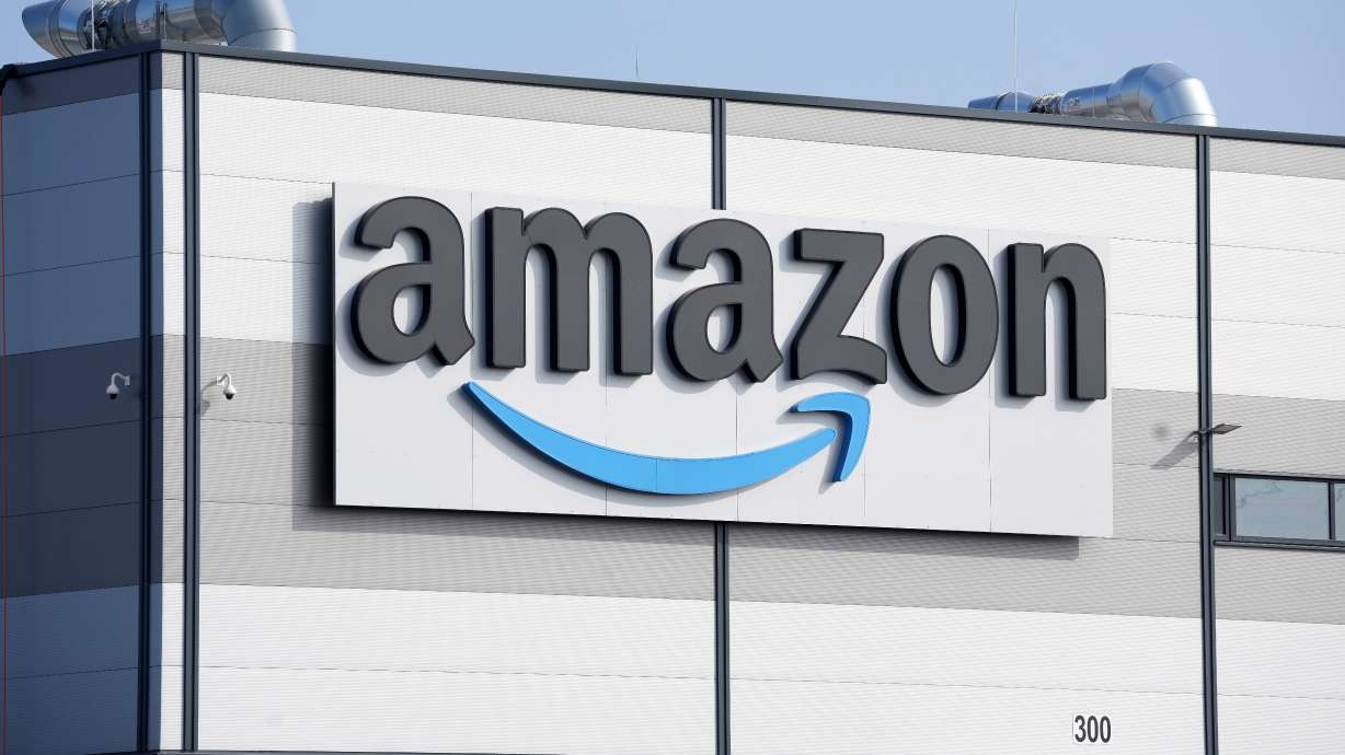 An Amazon company logo marks the facade of a building, March 18, 2022, in Schoenefeld near Berlin. Millions more people may be able to get smaller, lightweight Amazon packages delivered by drones by the end of the year.