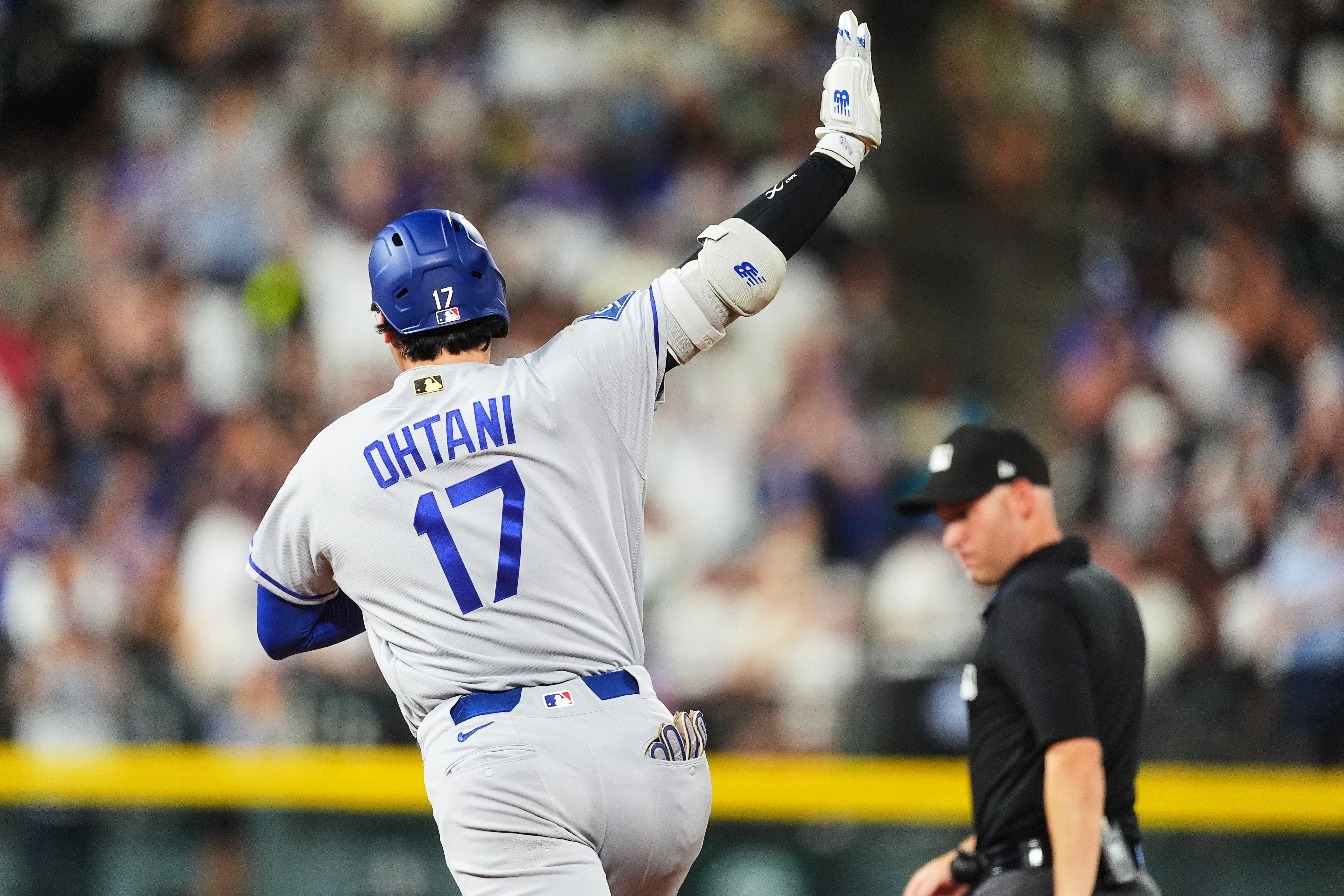 Los Angeles Dodgers' Shohei Ohtani (17) gestures to the bullpen as he circles the bases after hitting a two-run home run off Colorado Rockies relief pitcher Juan Mejia in the sixth inning of a baseball game Monday, Aug. 17, 2026, in Denver. 