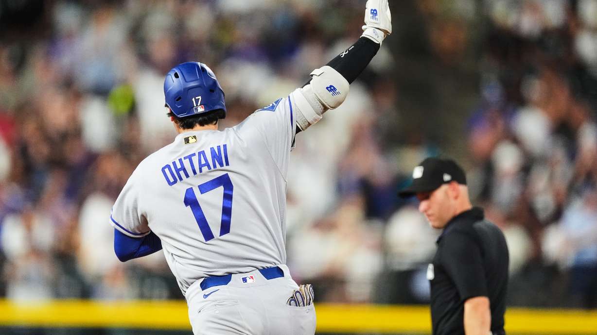 Los Angeles Dodgers' Shohei Ohtani (17) gestures to the bullpen as he circles the bases after hitting a two-run home run off Colorado Rockies relief pitcher Juan Mejia in the sixth inning of a baseball game Monday, Aug. 17, 2026, in Denver.