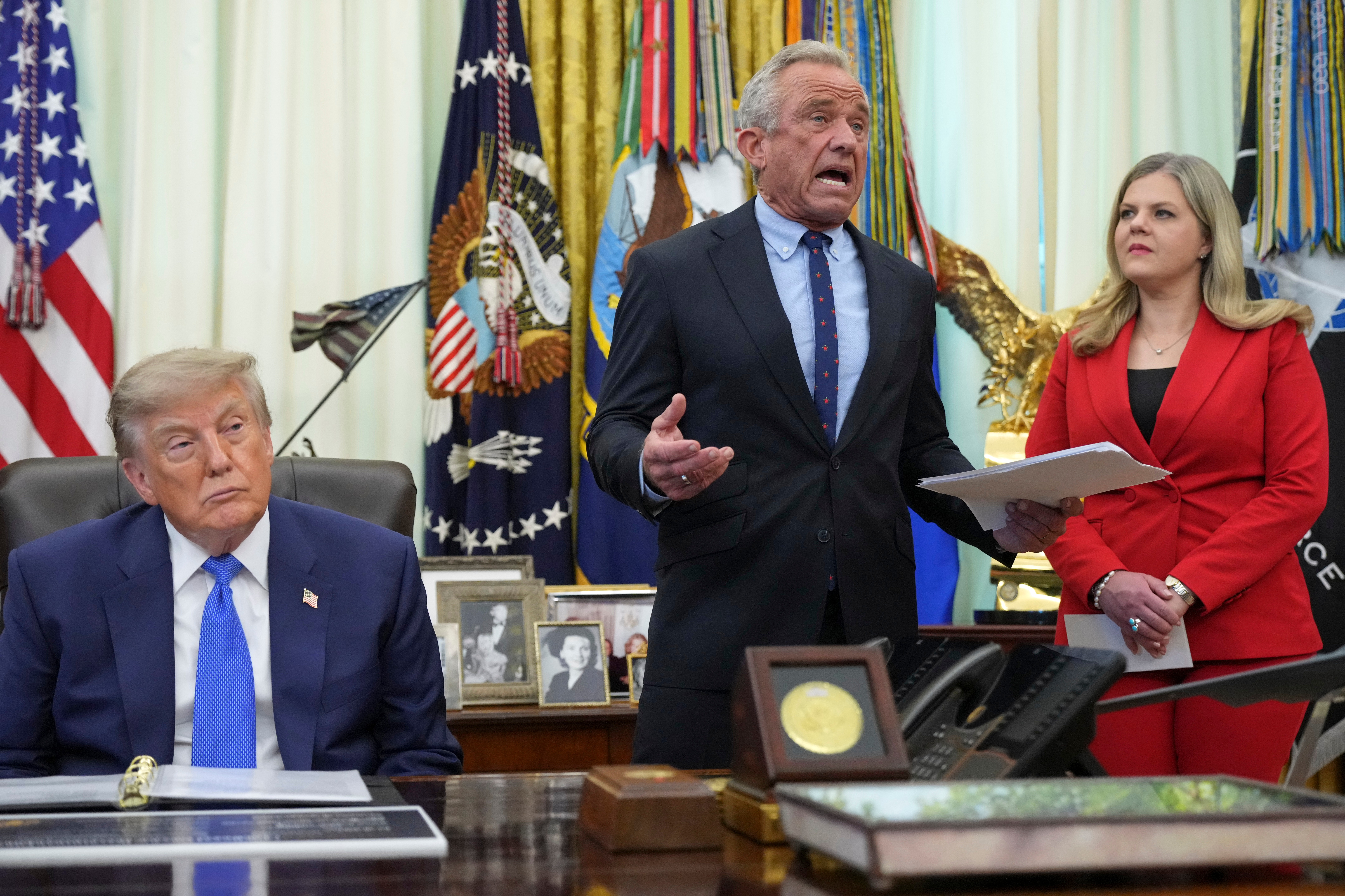 Health and Human Services Secretary Robert F. Kennedy Jr. speaks as President Donald Trump and Heidi Overton, deputy director of the White House Domestic Policy Council, listen during a meeting to sign an executive order about vaccines, Aug. 10, in the Oval Office in Washington. Overton was picked to lead the Food and Drug Administration on Wednesday.