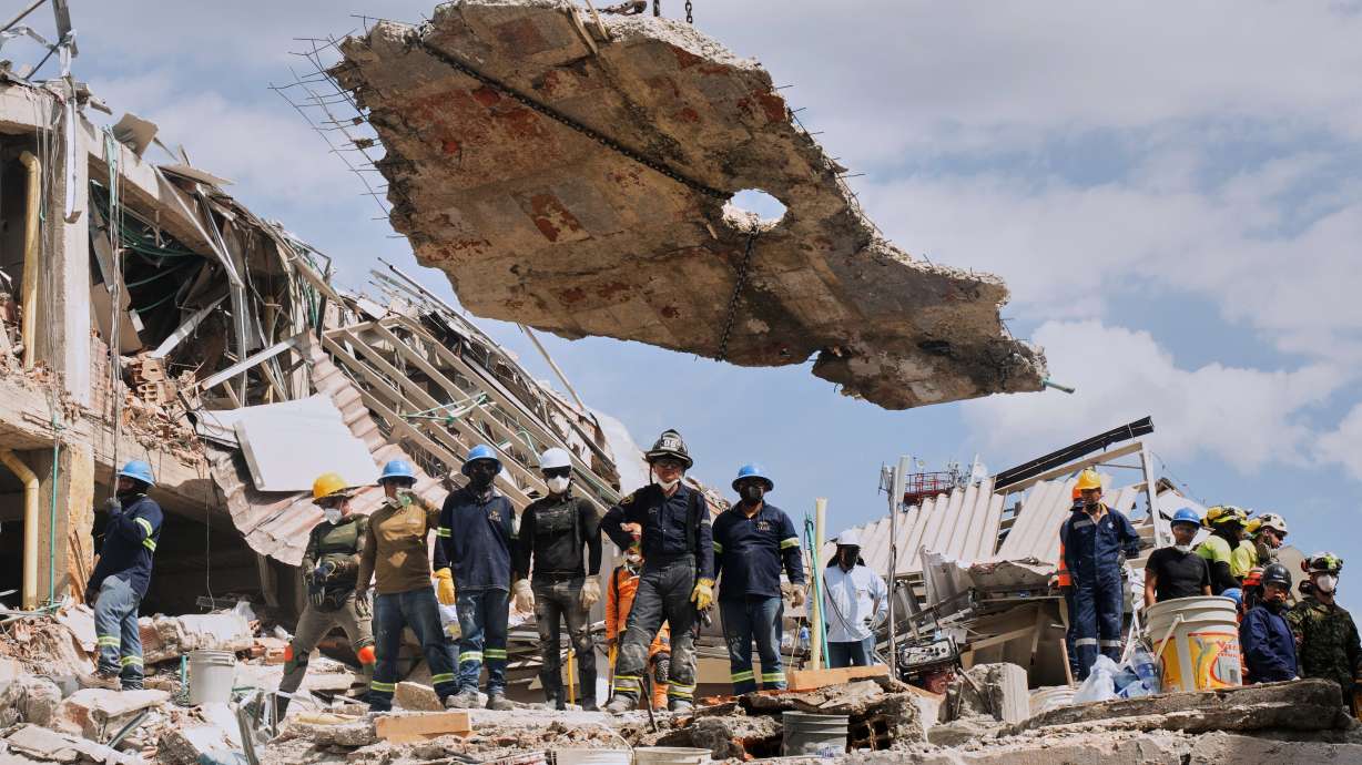 A crane lifts a concrete slab to clear the way for rescuers searching through the rubble three days after an earthquake hit Pereira, Colombia, Thursday. President Abelardo de la Esperiella asked President Donald Trump on Wednesday to suspend tariffs to help Colombia recover.