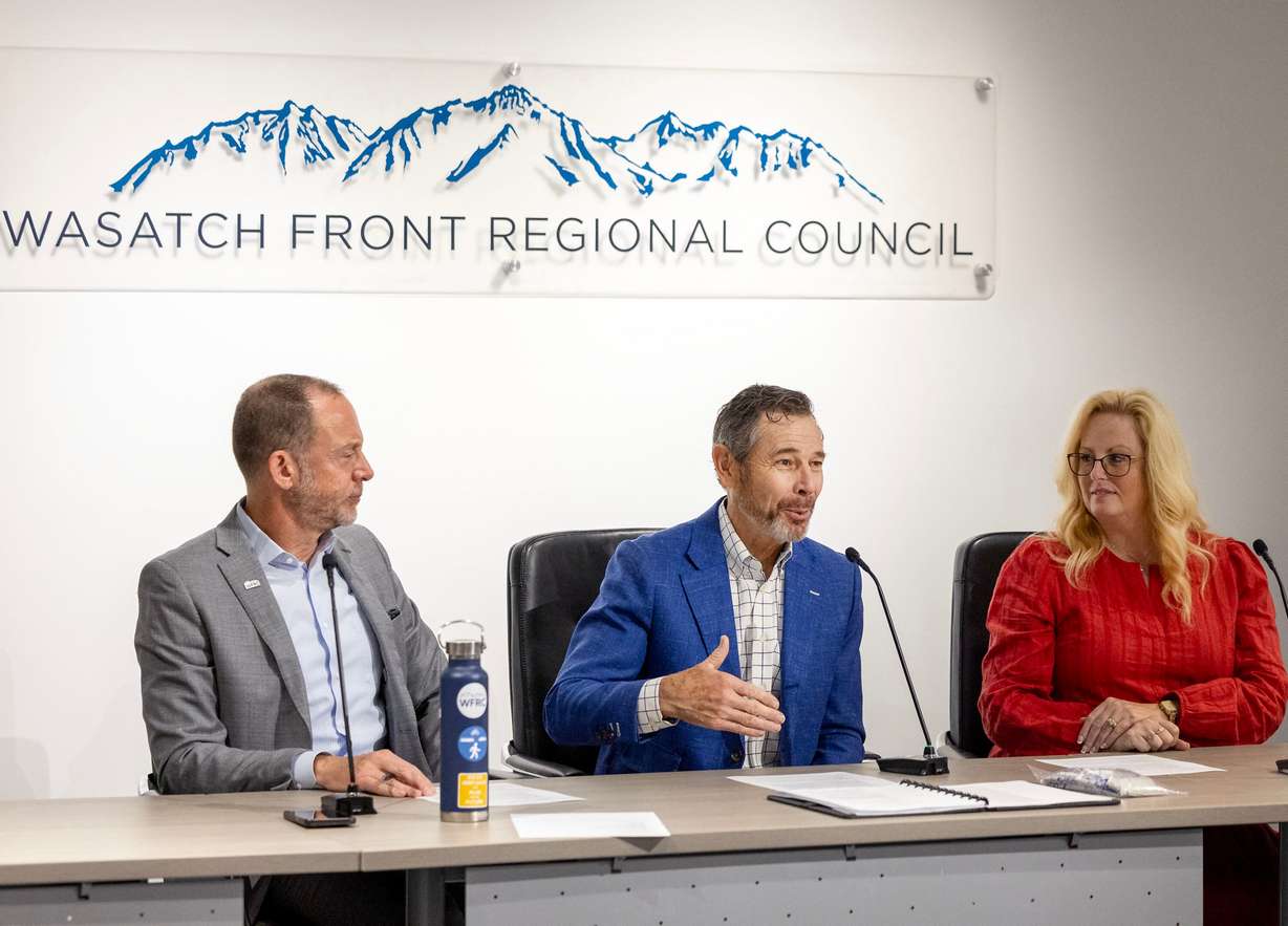Andrew Gruber, executive director of Wasatch Front Regional Council, left, Sen. John Curtis, and Dawn Ramsey, chair of the Wasatch Front Regional Council and the mayor of South Jordan, speak during a meeting with leaders from Utah Transit Authority and WFRC in Salt Lake City on Wednesday.