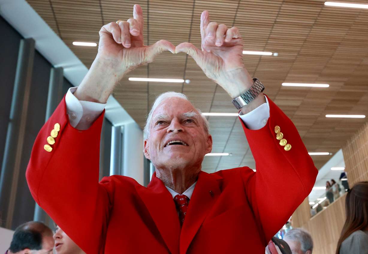 Spencer Fox Eccles, chairman and CEO of the George S. and Dolores Doré Eccles Foundation and the Nora Eccles Treadwell Foundation, makes a U symbol during the dedication ceremony for the new Spencer Fox Eccles School of Medicine at the University of Utah in Salt Lake City on Wednesday.