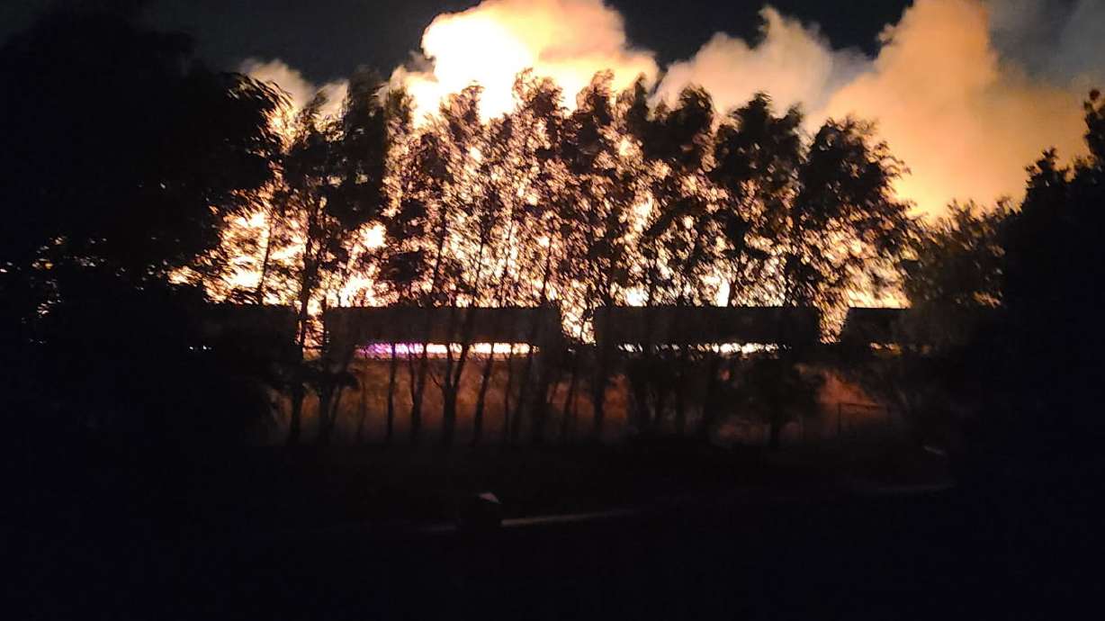 Flames just beyond the train tracks behind Allison Annis's home, early Wednesday morning. For some Uintah homeowners, the Dugway fire was a frightening reminder of a 2017 fire in the area that destroyed several homes.