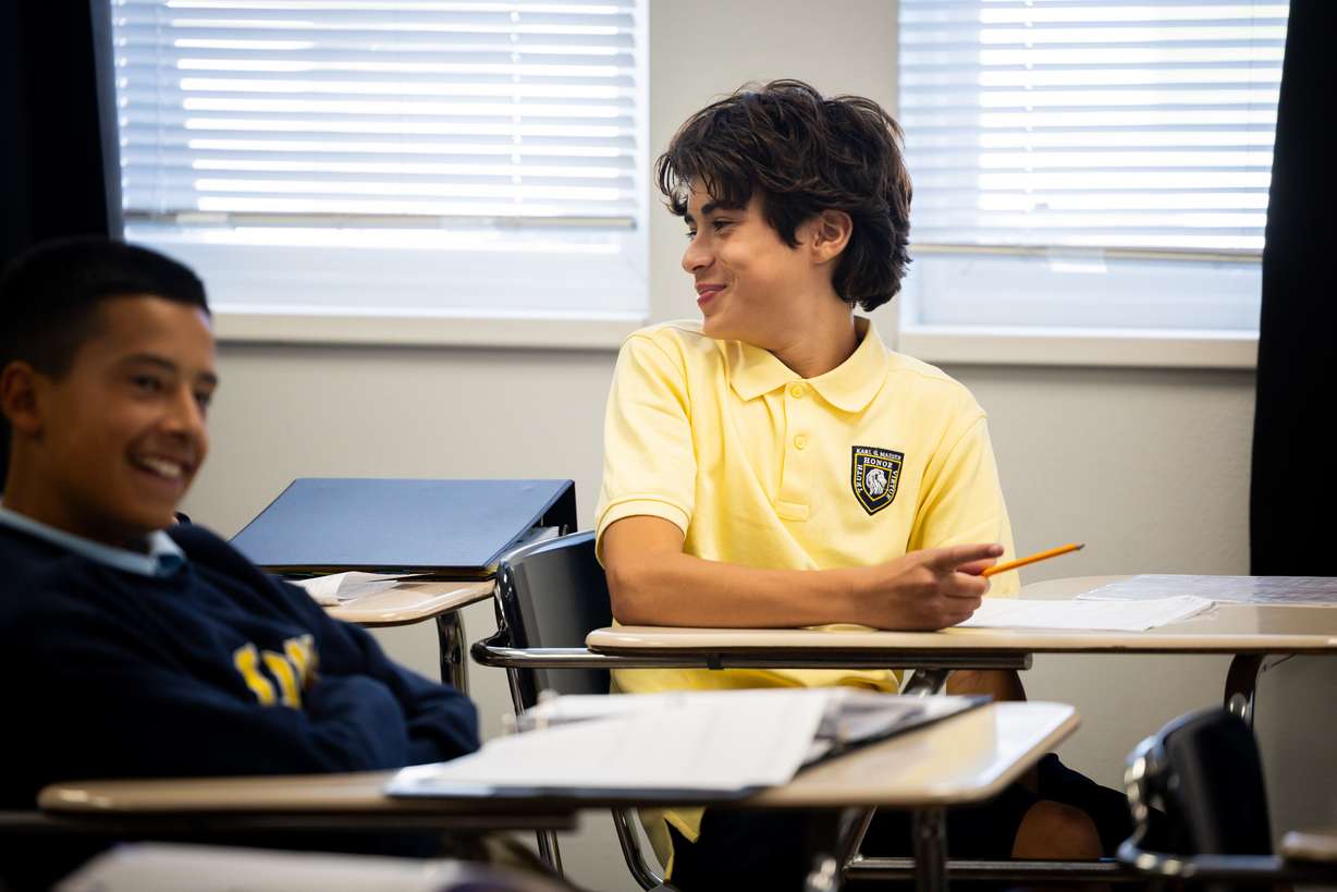 Ricco Oliveira, 14, smiles in a 8th grade history class at Karl Maeser Preparatory Academy in Lindon on Wednesday. Karl Maeser Preparatory Academy was selected as Utah's top high school.