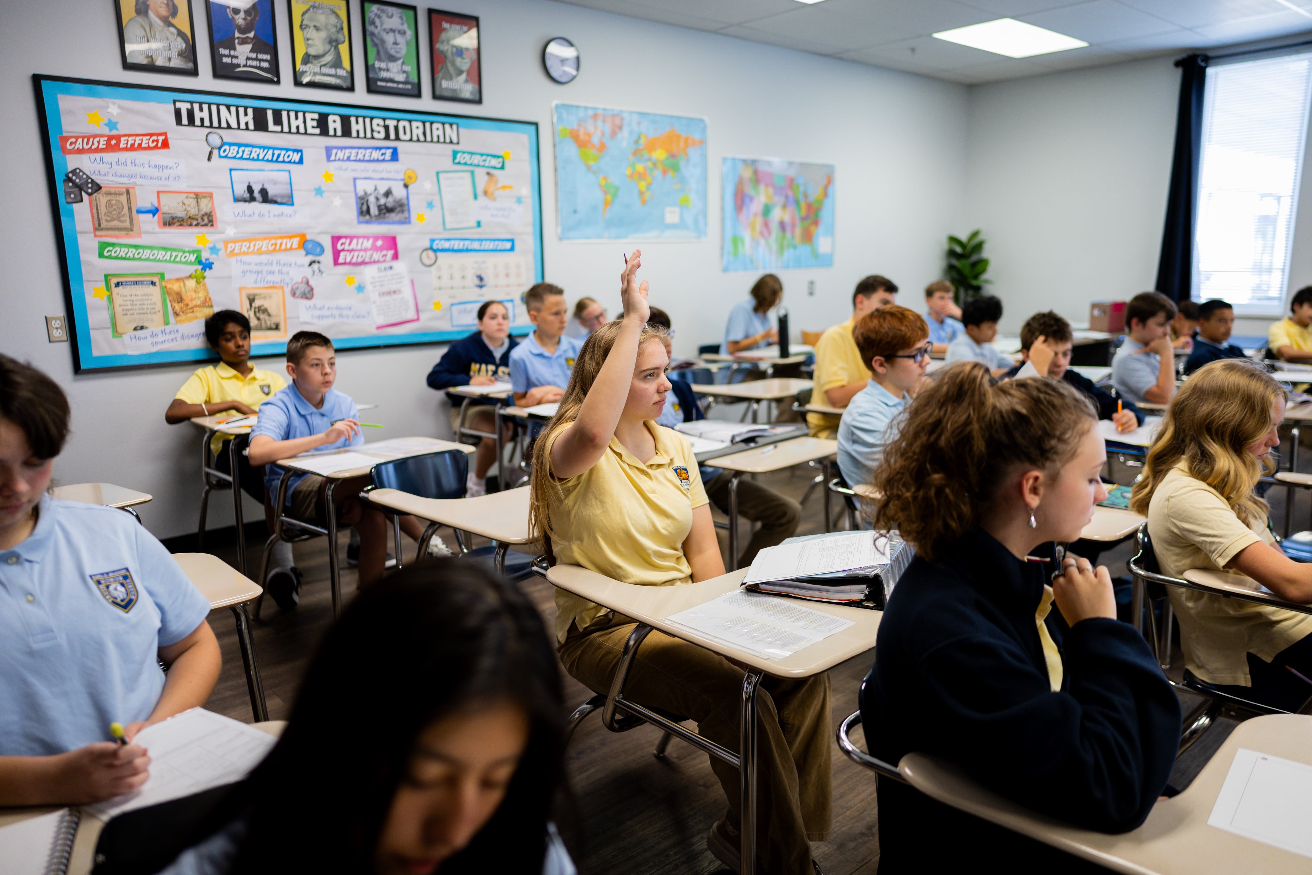 Elizabeth Morris, 13, raises her hand in a 8th grade history class at Karl Maeser Preparatory Academy in Lindon on Wednesday. Karl Maeser Preparatory Academy was selected as Utah's top high school.