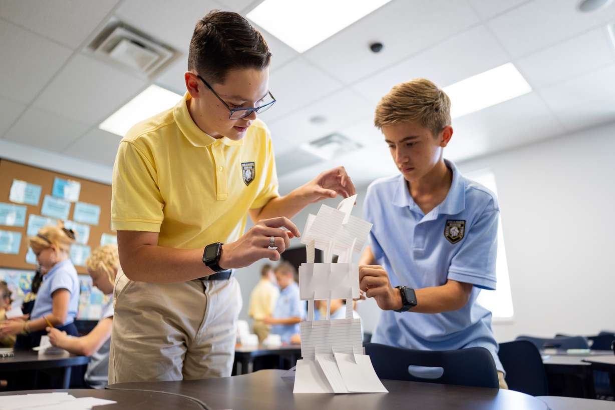 Noah Doermann, 13, and Koen Sellers, 13, attempt to build the highest tower in their 7th grade science class at Karl Maeser Preparatory Academy in Lindon on Wednesday. Karl Maeser Preparatory Academy was selected as Utah's top high school.