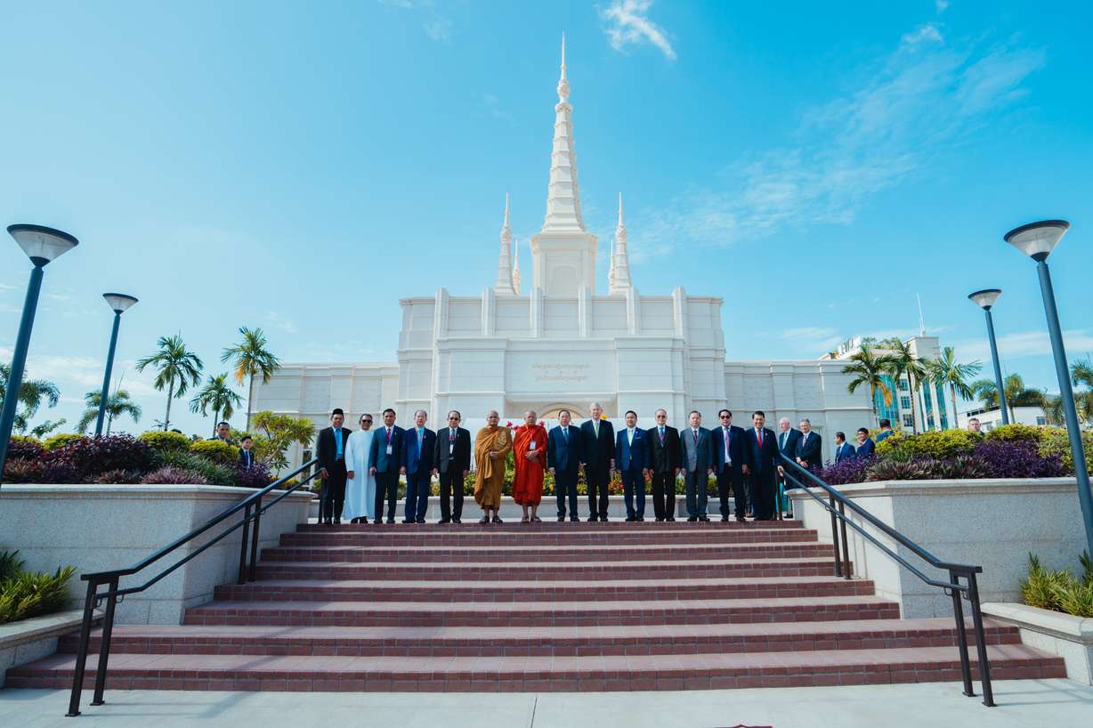 A diverse group of government and interfaith leaders pose for a photo in front of the Phnom Penn Cambodia Temple on Aug. 12, during the temple's open house celebration and media day, including Elder Gerrit W. Gong of the Quorum of the Twelve Apostles of The Church of Jesus Christ of Latter-day Saints and His Excellency Minister of Cult and Religion Dr. Chay Borin (center).