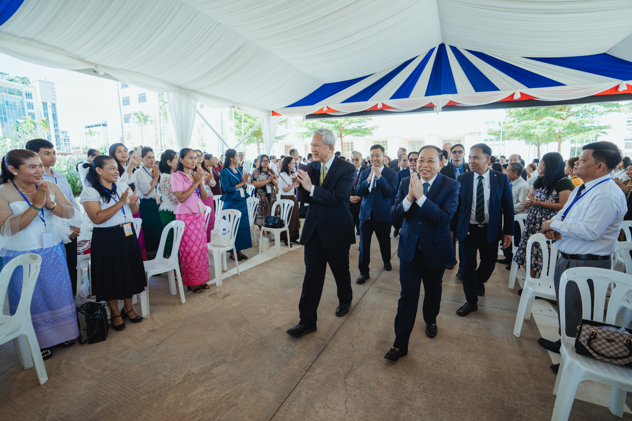 Elder Gerrit W. Gong of the Quorum of the Twelve Apostles of The Church of Jesus Christ of Latter-day Saints and His Excellency Minister of Cult and Religion Dr. Chay Borin, who was the guest of honor at the Phnom Penh Cambodia Temple open house celebration ceremony on August 12, give the traditional sampeah greeting to around 600 in attendance.