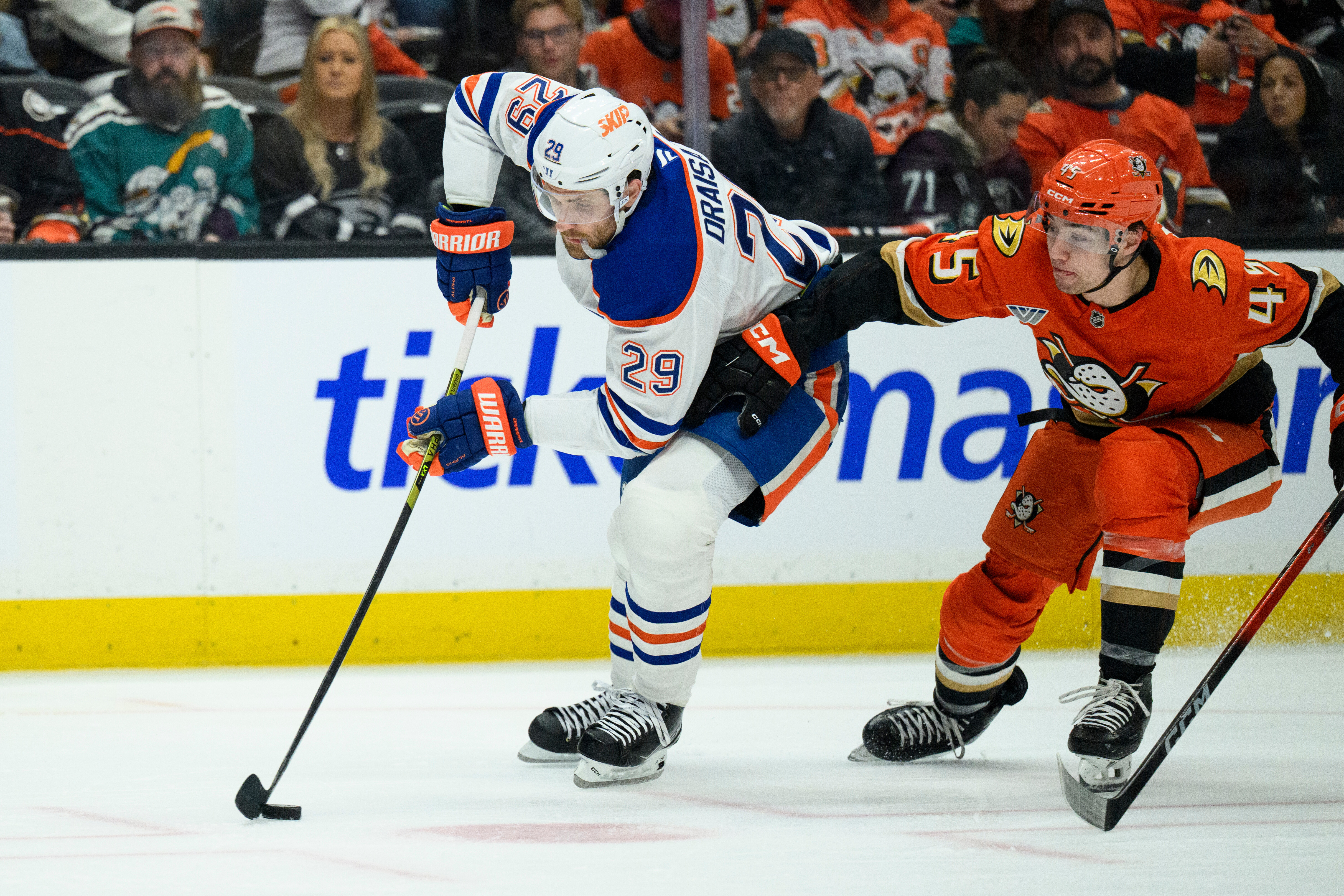 FILE - Edmonton Oilers center Leon Draisaitl, left, controls the puck as Anaheim Ducks right wing Beckett Sennecke defends during the second period of Game 4 in the first round of an NHL hockey Stanley Cup playoff series Sunday, April 26, 2026, in Anaheim, Calif. , File)