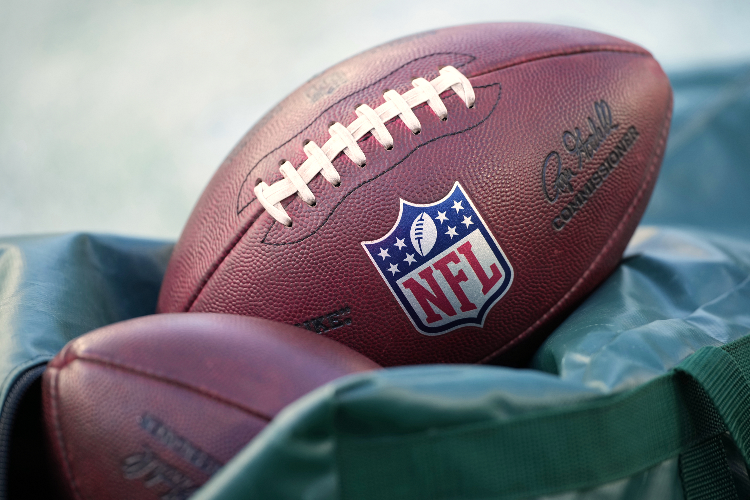 FILE - Footballs are seen before an NFL football game in Philadelphia on Jan. 4, 2026. 