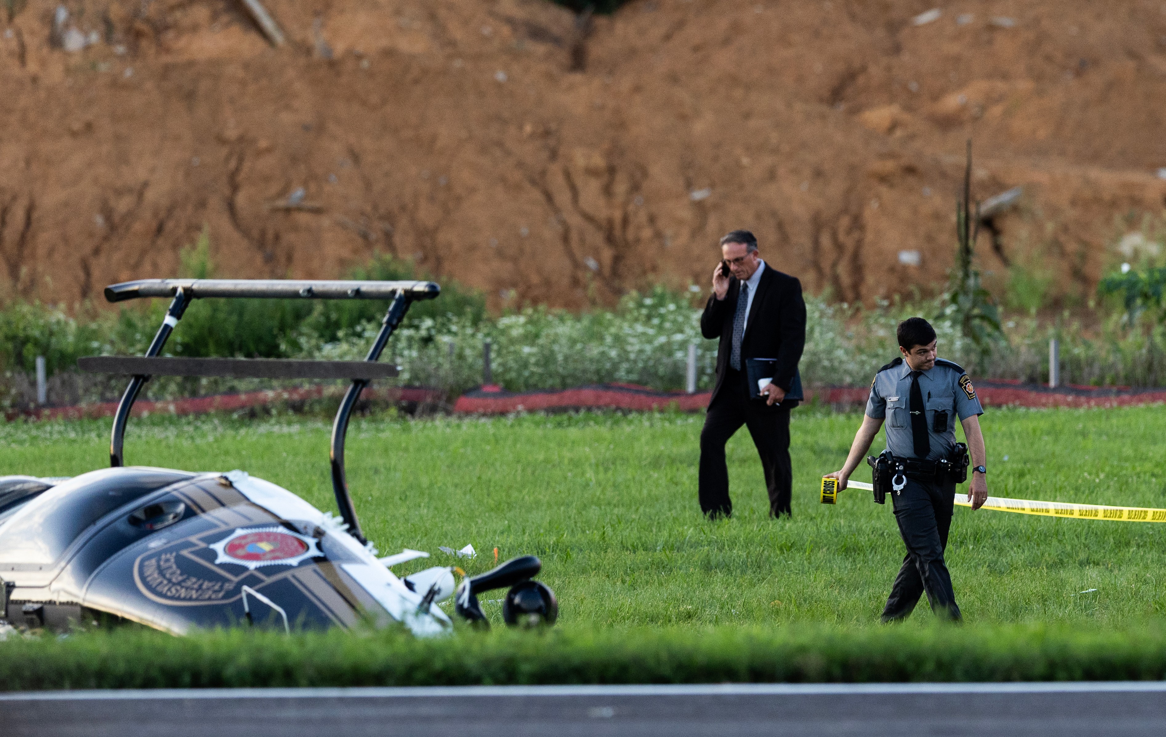 Authorities investigate a crash between a Pennsylvania State Police helicopter and a small plane at the Carlisle airport in Carlisle, Pa. Wednesday, Aug. 19, 2026. 