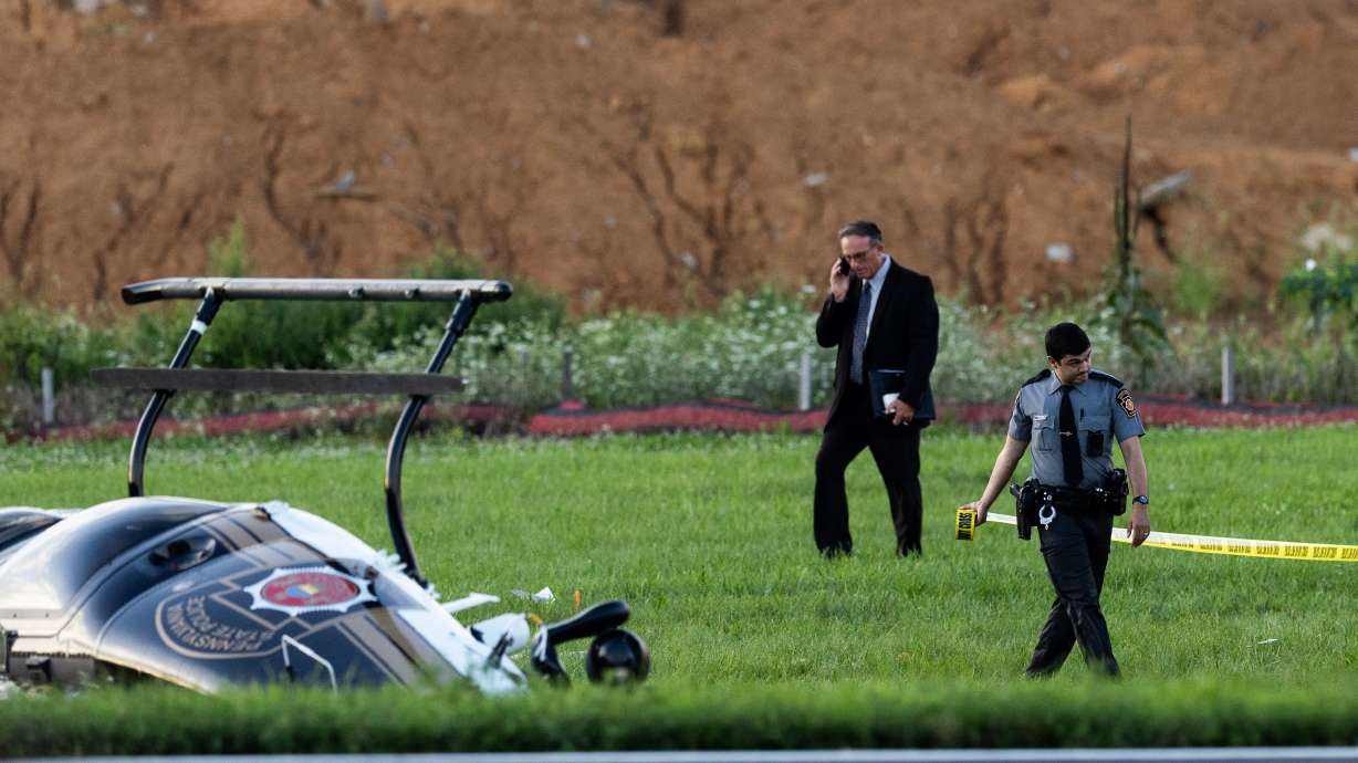 Authorities investigate a crash between a Pennsylvania State Police helicopter and a small plane at the Carlisle airport in Carlisle, Pa. Wednesday, Aug. 19, 2026.