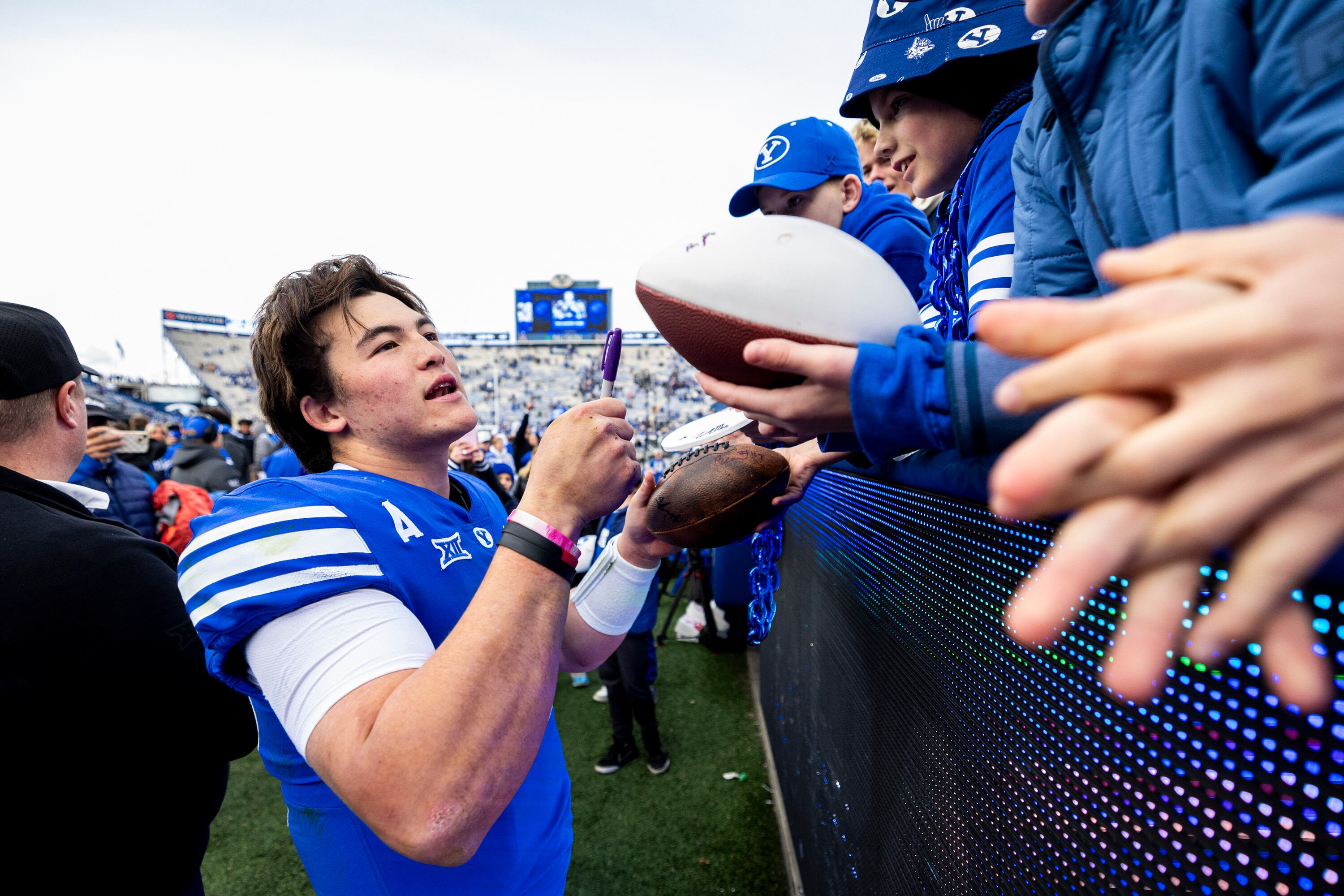 BYU quarterback Bear Bachmeier (47) signs items for fans after the Cougars defeated the UCF Knights in an NCAA football game held at LaVell Edwards Stadium in Provo on Saturday, Nov. 29, 2025.