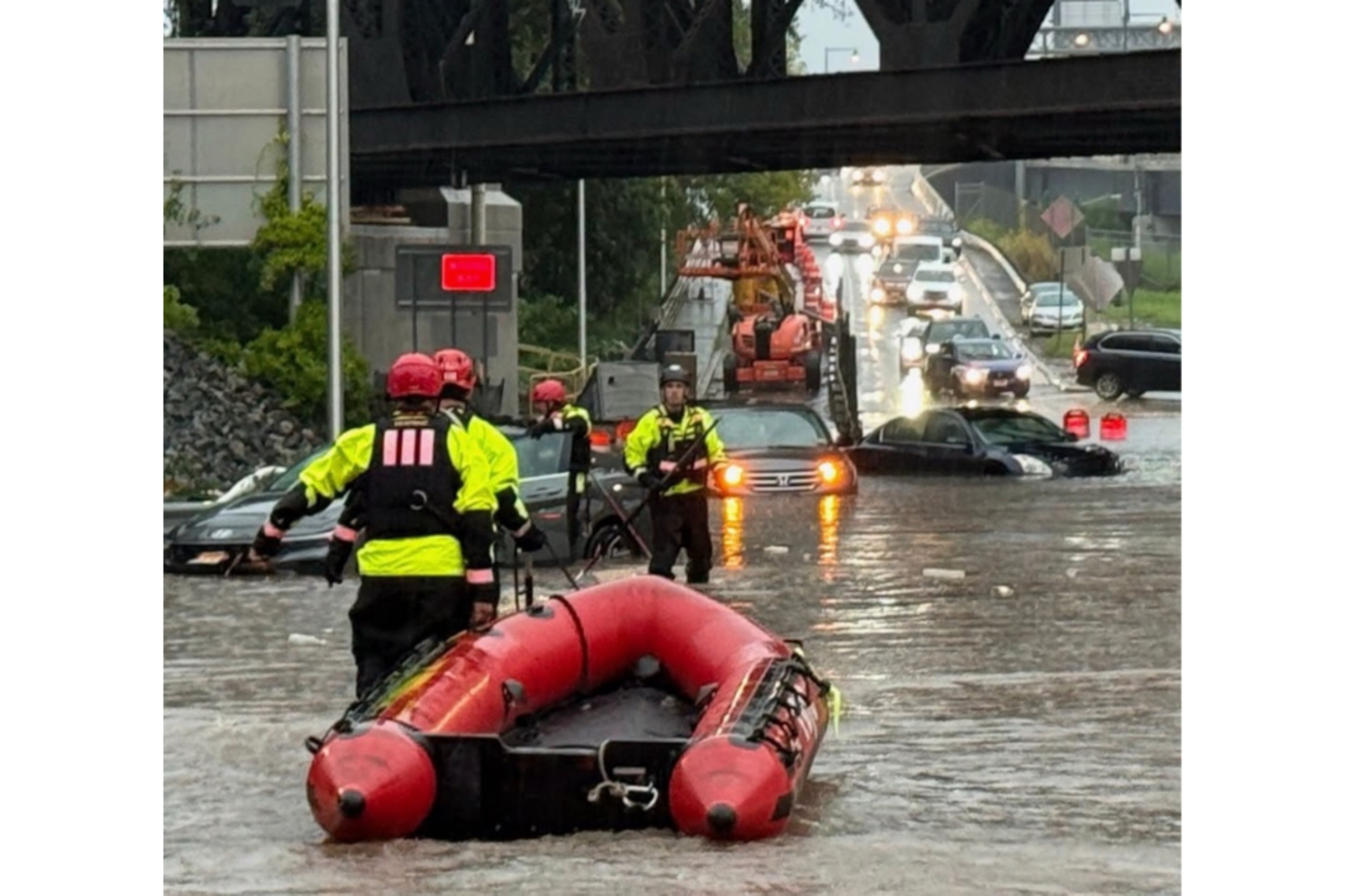 In this photo provided by the City of Jersey City, first responders try to rescue people stranded in Jersey City, N.J., Thursday, Aug. 20, 2026, after storms went through the area. 