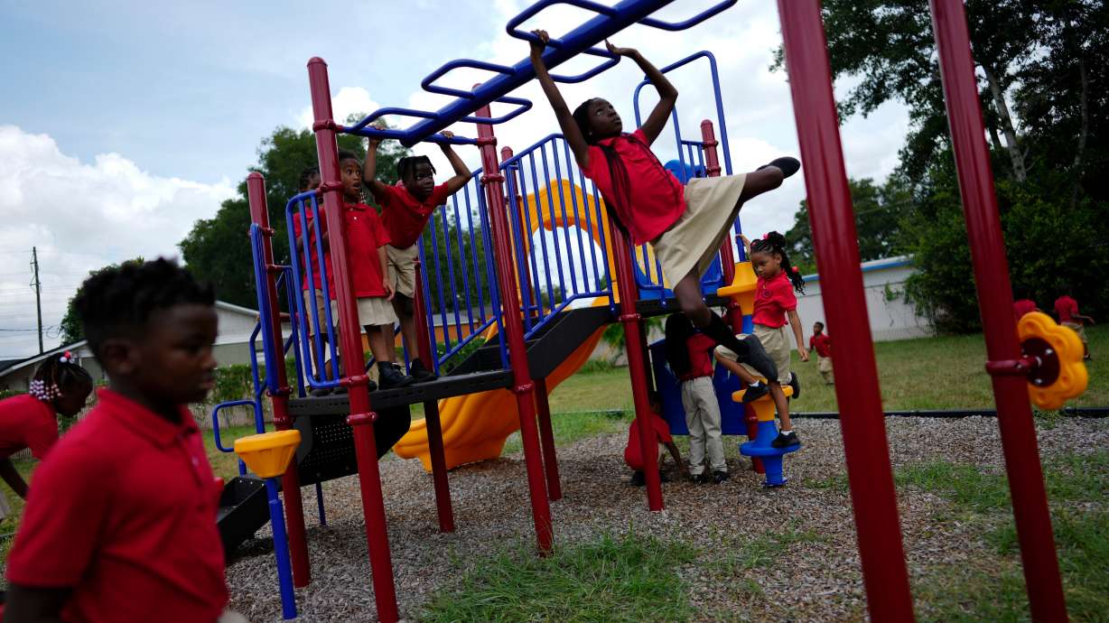Students from Thomas Leadership Academy play on the school's playground in Eatonville, Fla., on Aug. 23, 2023.
