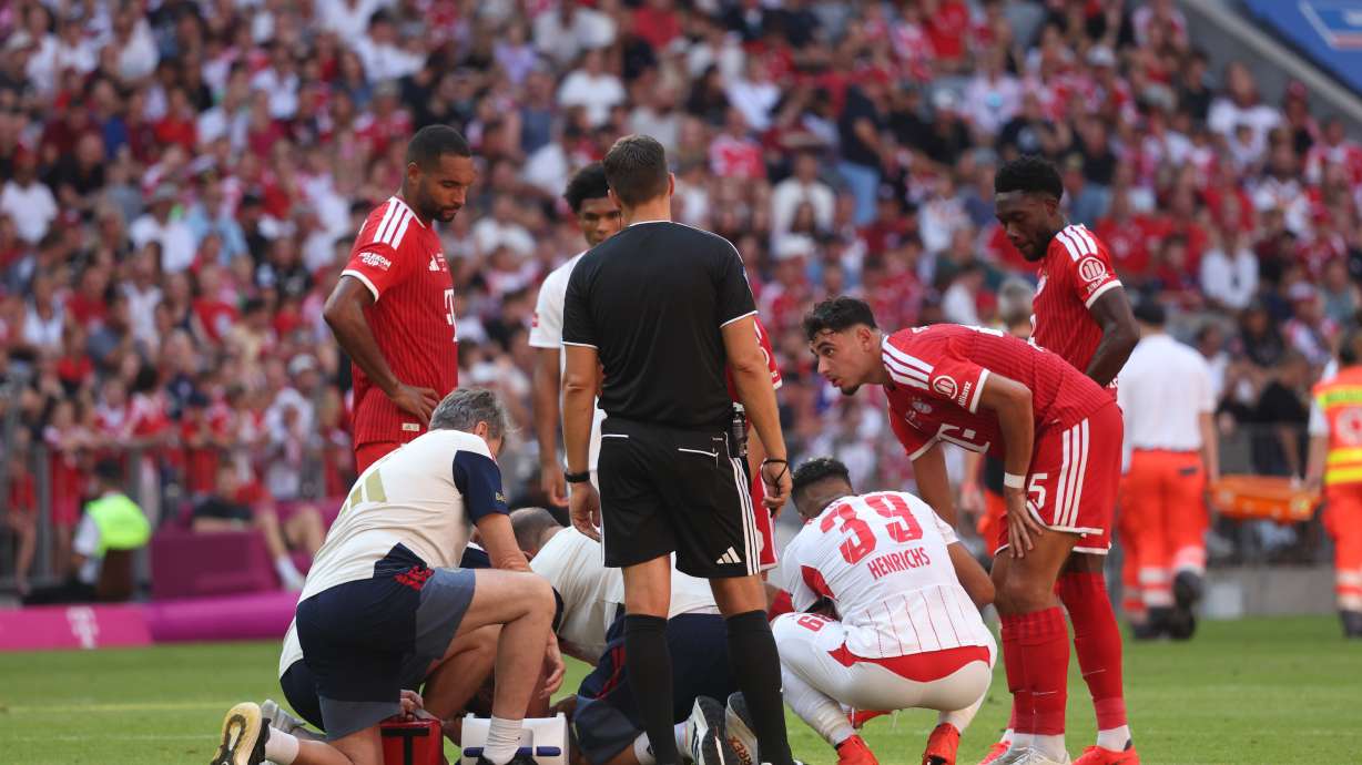 Munich's Jamal Musiala receives medical treatment during a pre-season soccer match between FC Bayern Munich and RB Leipzig in Munich, Germany, Saturday, Aug. 15, 2026.