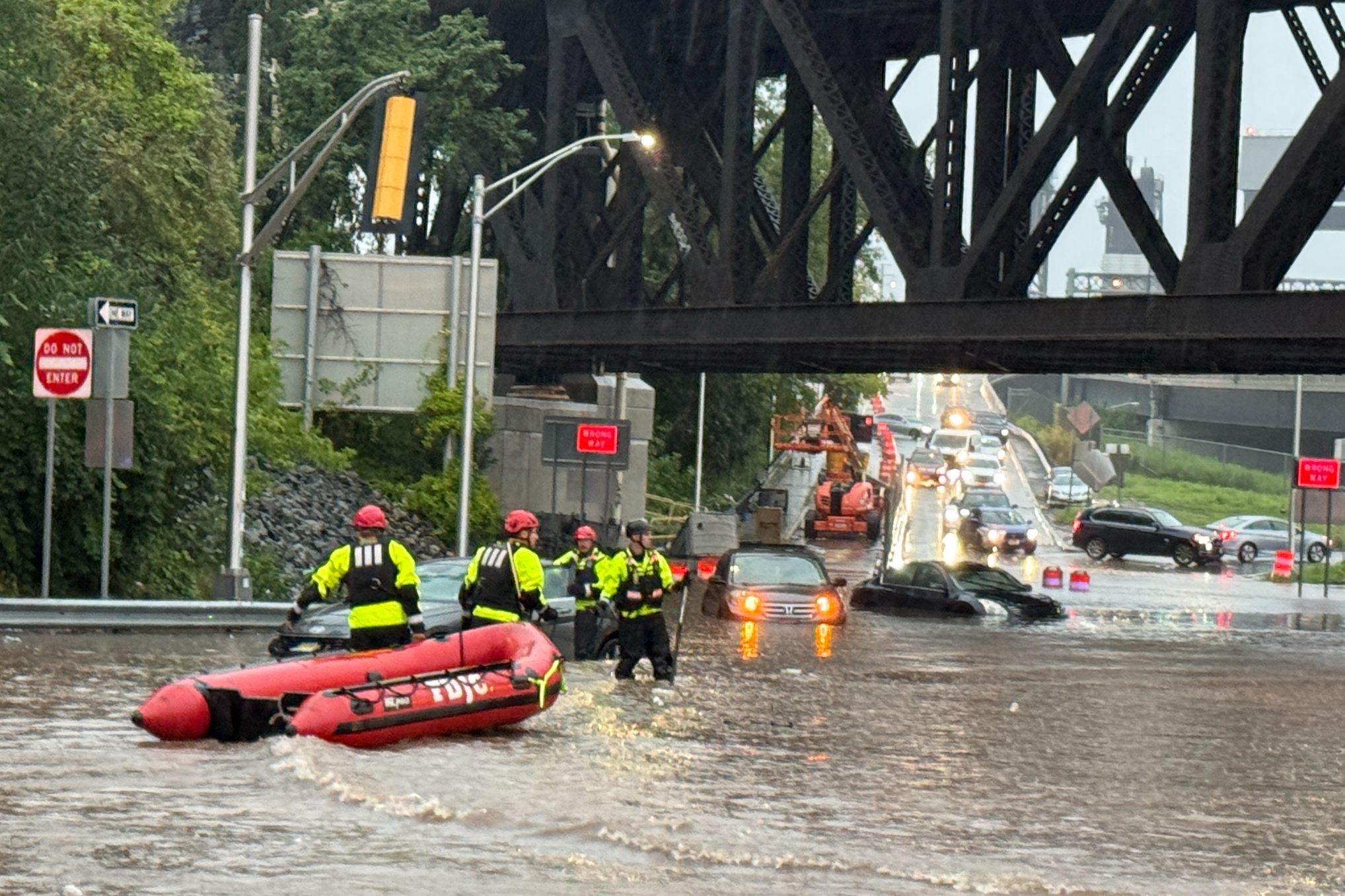 In this photo provided by the City of Jersey City, first responders try to rescue people stranded in a flooded street in Jersey City, N.J., Thursday, Aug. 20, 2026, after storms went through the area. 