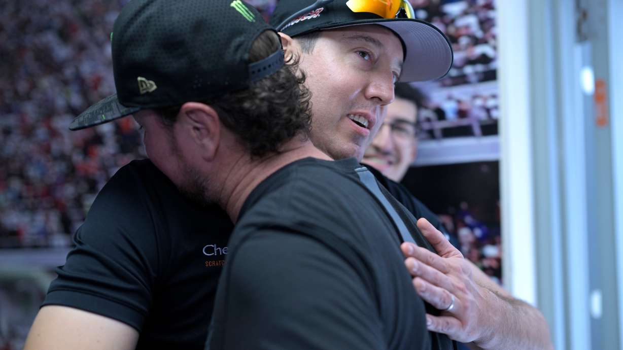 FILE - Kurt Busch, front, gets a hug from his brother, Kyle Busch, after announcing his retirement before a NASCAR Cup Series auto race at Daytona International Speedway, Aug. 26, 2023, in Daytona Beach, Fla.