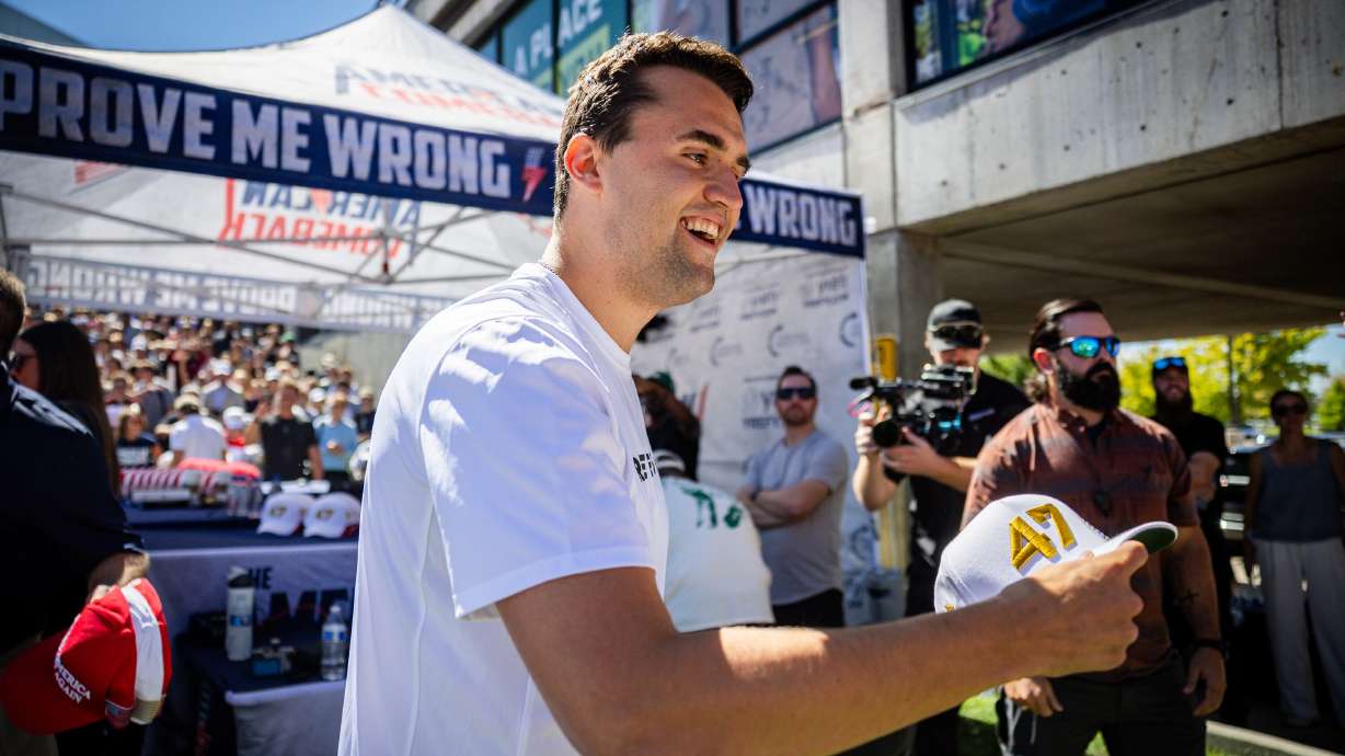 Charlie Kirk hands out hats before he was shot during Turning Point USA’s visit to Utah Valley University in Orem on Sept. 10, 2025. Turning Point USA announced it will hold a memorial to commemorate Kirk at UVU.