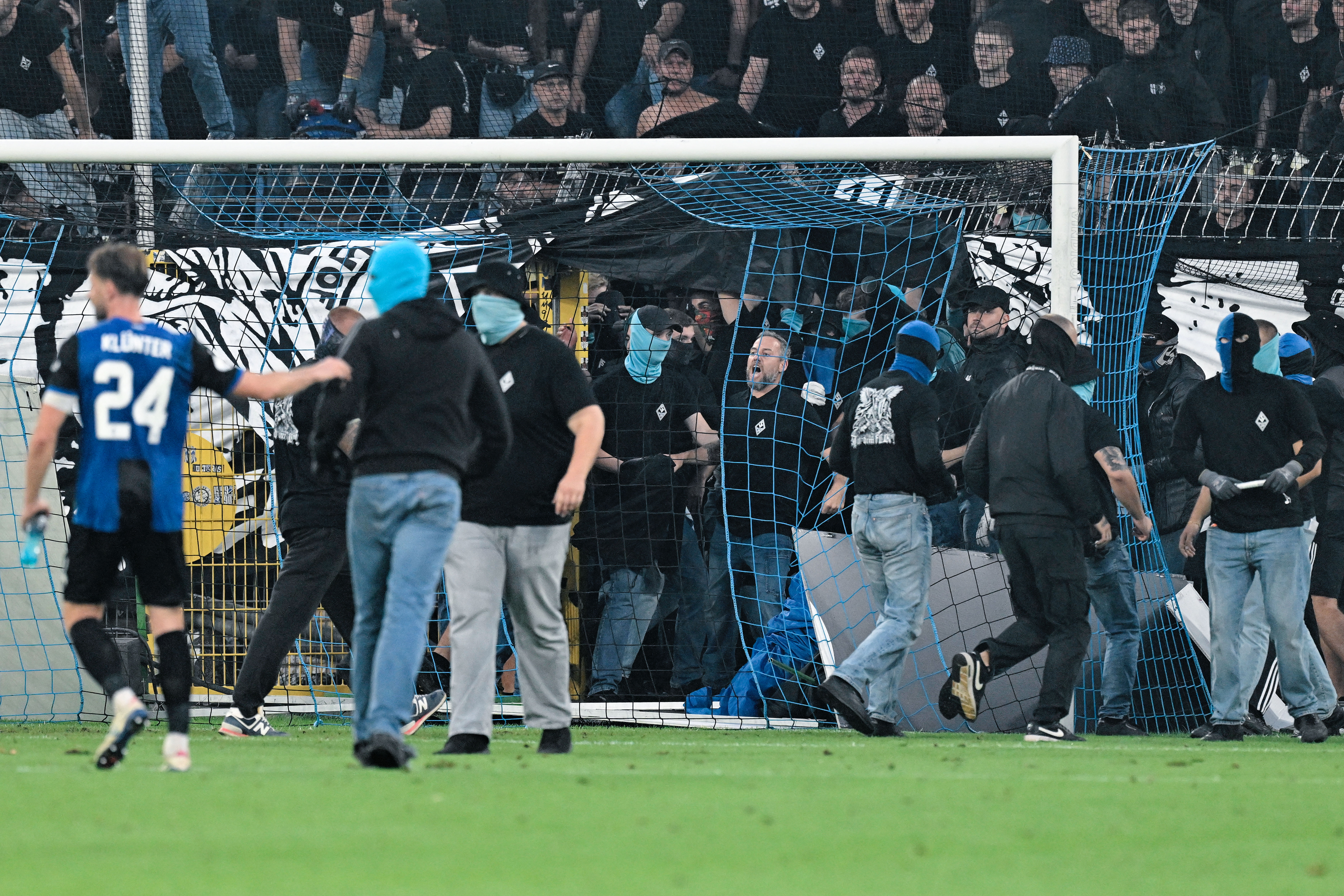 SV Mannheim supporters storm the field during the Germany Cup soccer match between SV Waldhof Mannheim and 1. FC Kaiserslautern, Friday, Aug. 21, 2026, in Mannheim, Germany. 