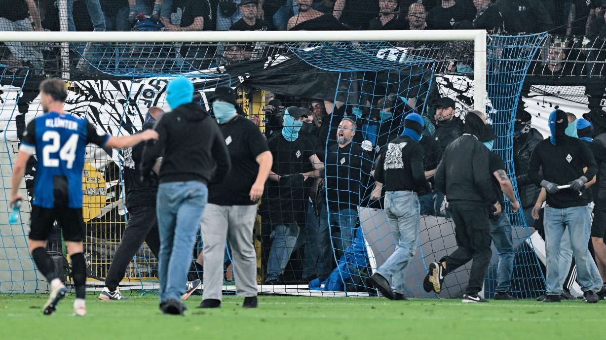 SV Mannheim supporters storm the field during the Germany Cup soccer match between SV Waldhof Mannheim and 1. FC Kaiserslautern, Friday, Aug. 21, 2026, in Mannheim, Germany.
