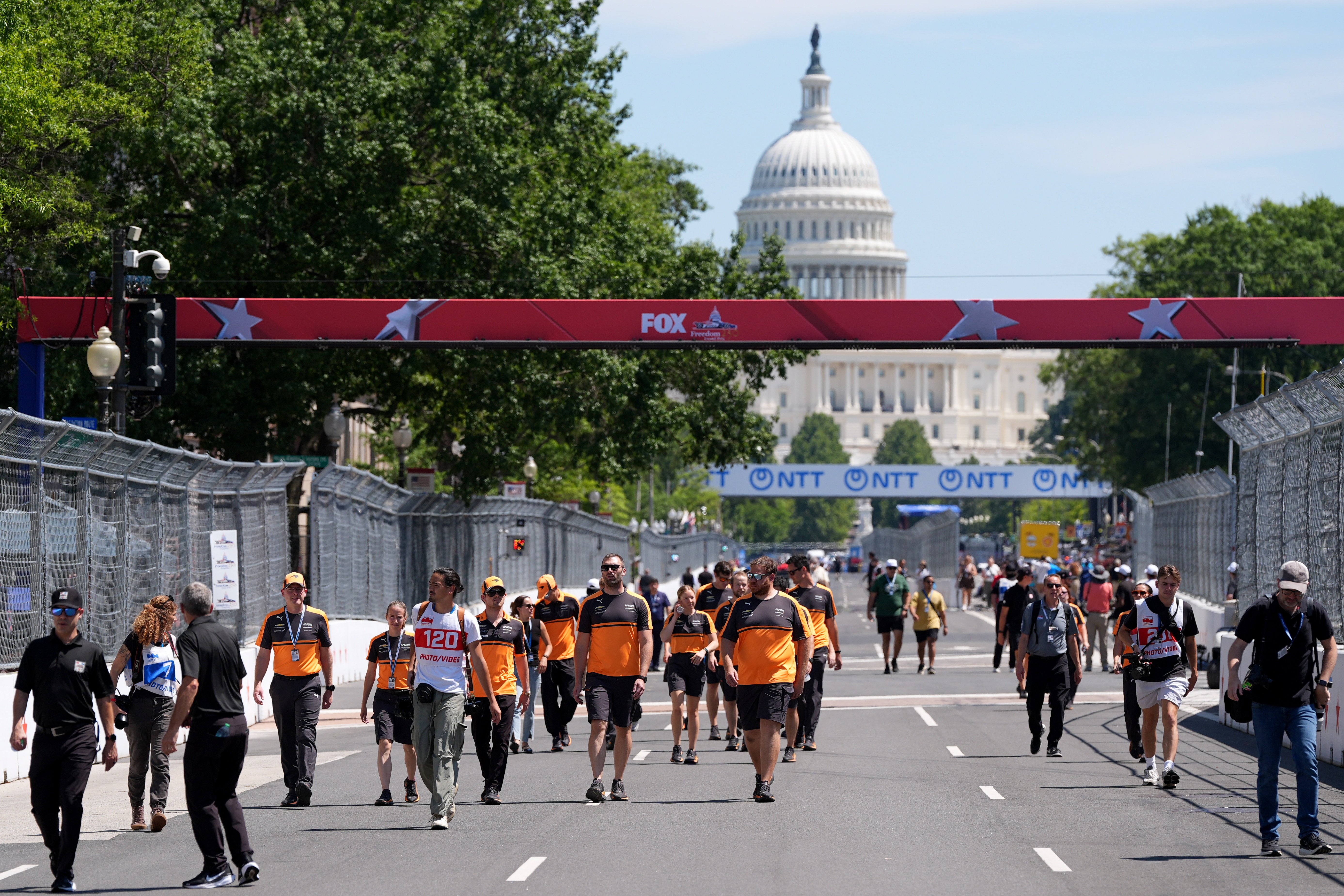 Racing teams walk the track before Sunday's Freedom 250 Grand Prix auto race, seen Friday, Aug. 21, 2026, in Washington. 