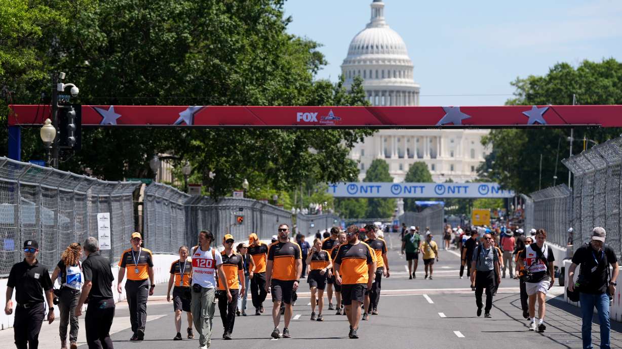 Racing teams walk the track before Sunday's Freedom 250 Grand Prix auto race, seen Friday, Aug. 21, 2026, in Washington.