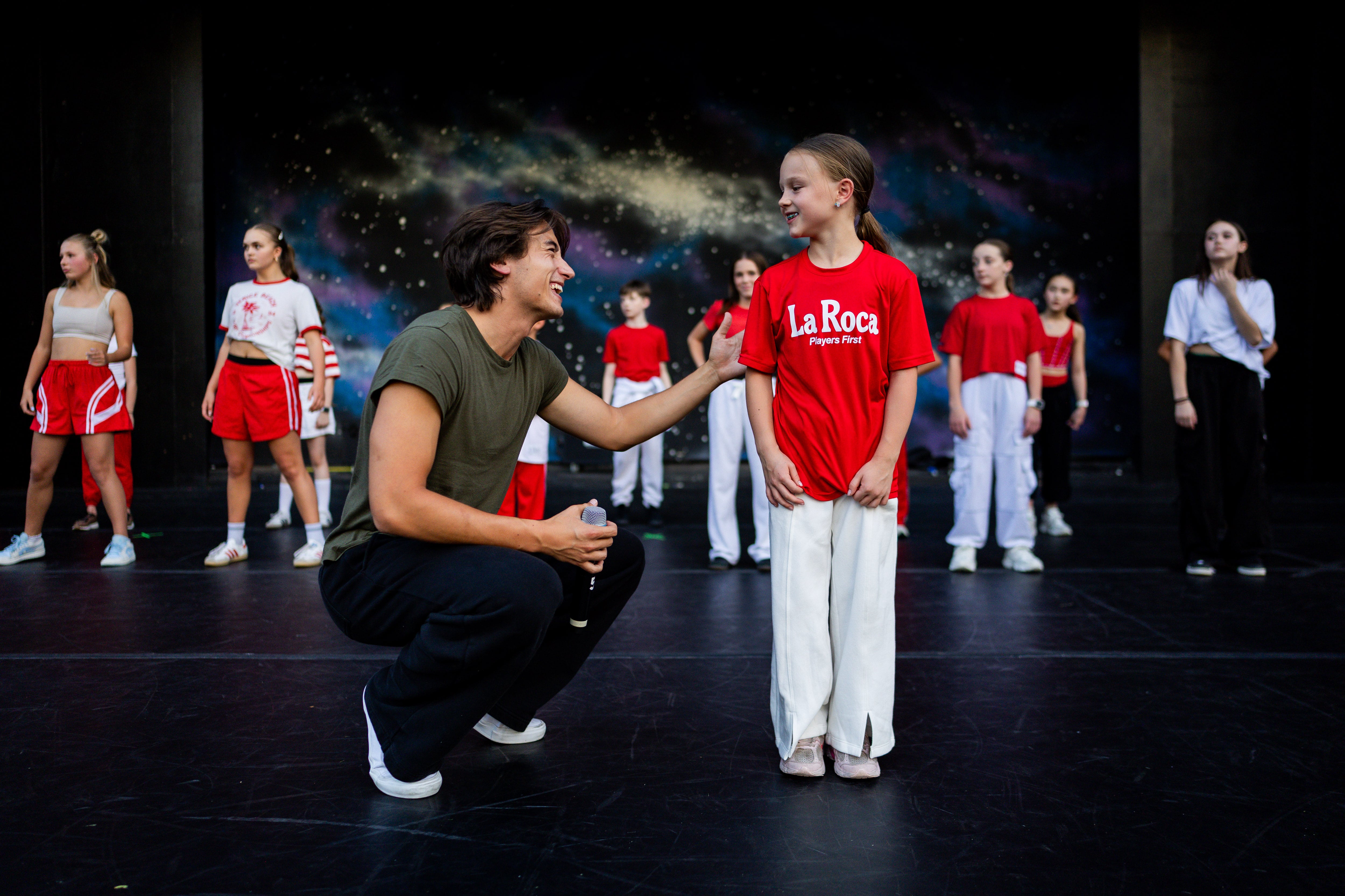 Jagger Moon, from Utah, a member of the Full Circle Boys, left, and Maylee Allman, 9, right, along with dancers from Center Stage Performing Arts studio, Hi-Light Dance and Charisma Dance Studio rehearse for the 21st annual "Dancing Under the Stars" at the SCERA Shell Outdoor Theatre  in Orem on Thursday.