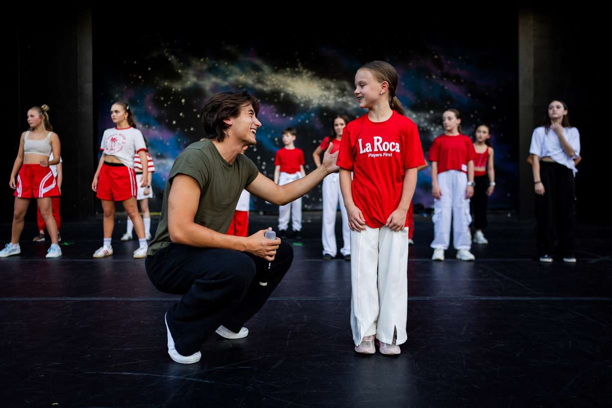 Jagger Moon, from Utah, a member of the Full Circle Boys, left, and Maylee Allman, 9, right, along with dancers from Center Stage Performing Arts studio, Hi-Light Dance and Charisma Dance Studio rehearse for the 21st annual "Dancing Under the Stars" at the SCERA Shell Outdoor Theatre in Orem on Thursday.