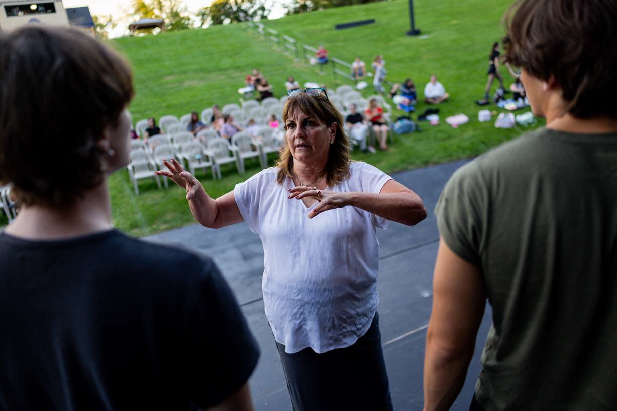 Kim DelGrosso, co-owner of Center Stage Performing Arts studio, center, talks with the Full Circle Boys as they rehearse for the 21st annual "Dancing Under the Stars" at the SCERA Shell Outdoor Theatre in Orem on Thursday.