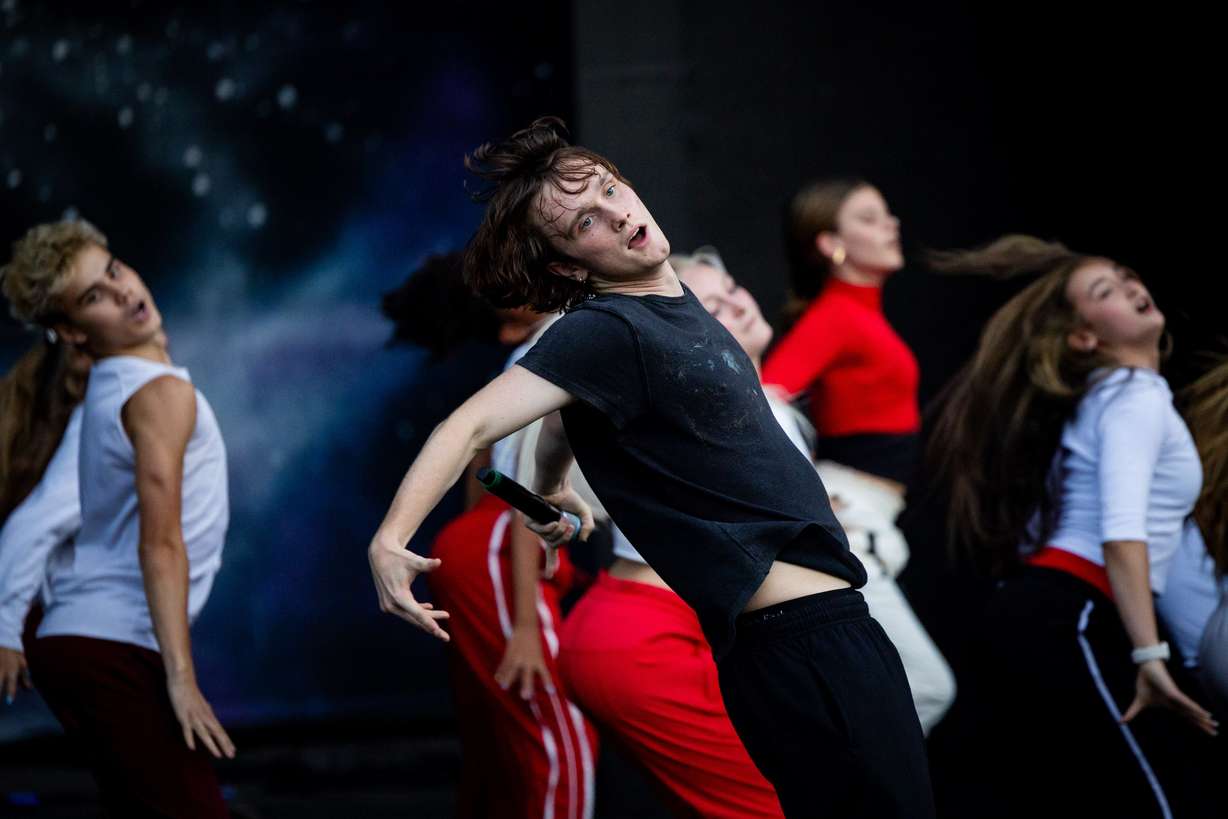 Oliver Hincy, from Utah, a member of the Full Circle Boys, and dancers from Center Stage Performing Arts studio, Hi-Light Dance and Charisma Dance Studio rehearse for the 21st annual "Dancing Under the Stars" at the SCERA Shell Outdoor Theatre in Orem on Thursday.